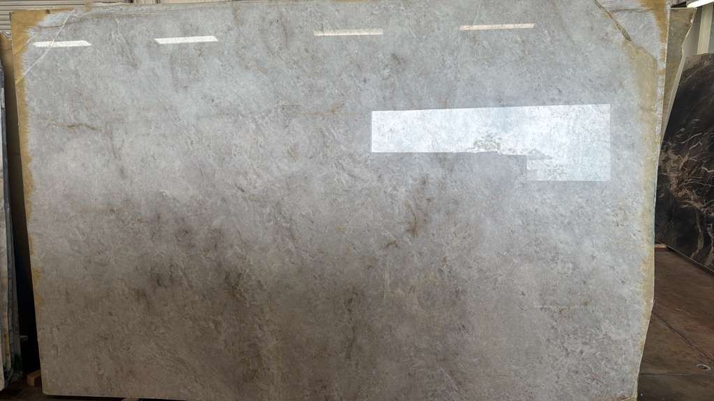 A weathered gray sheet with a white rectangular label taped near the upper right.