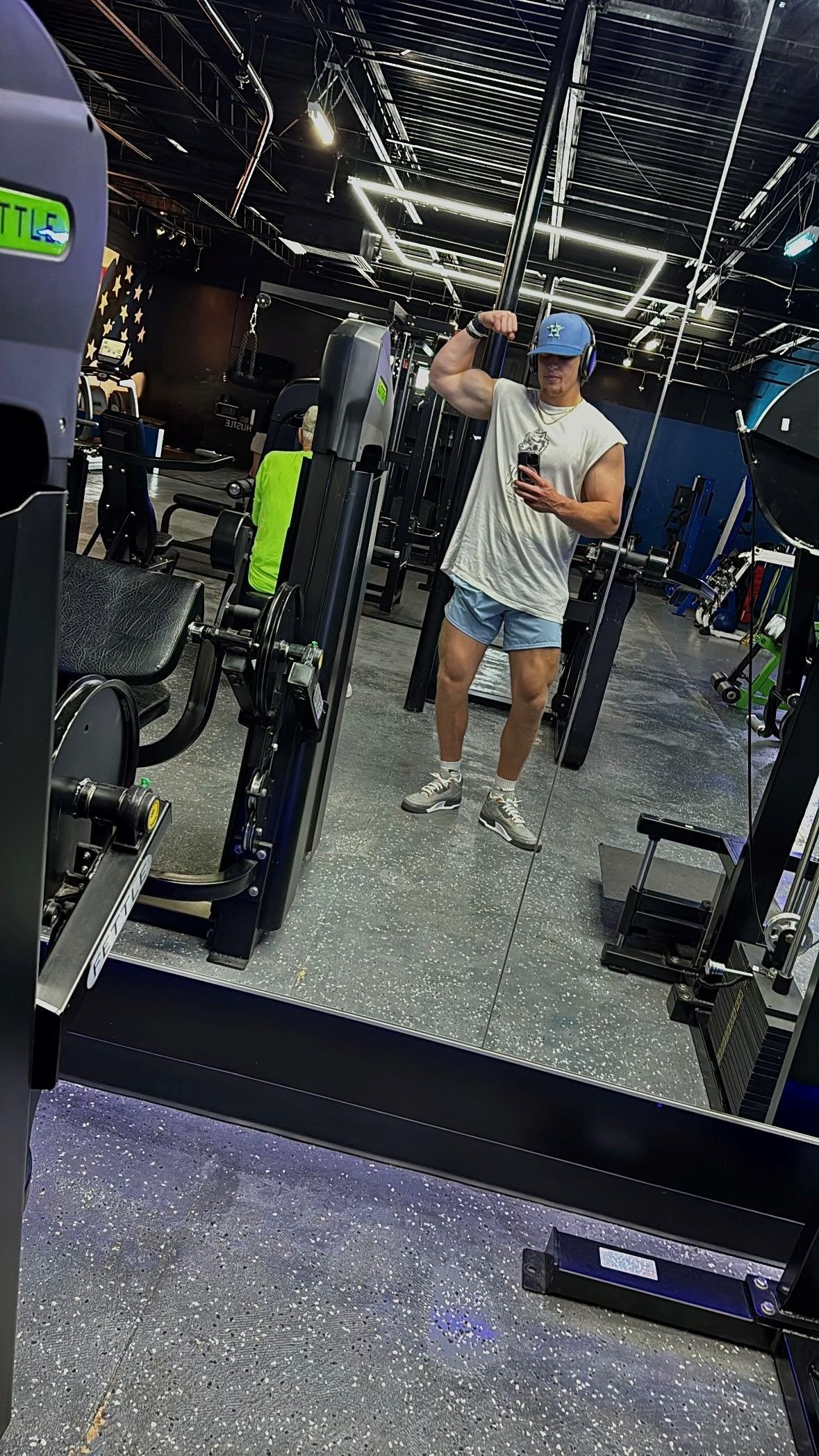 Jack Mulkhern is taking a picture of himself in a gym mirror.
