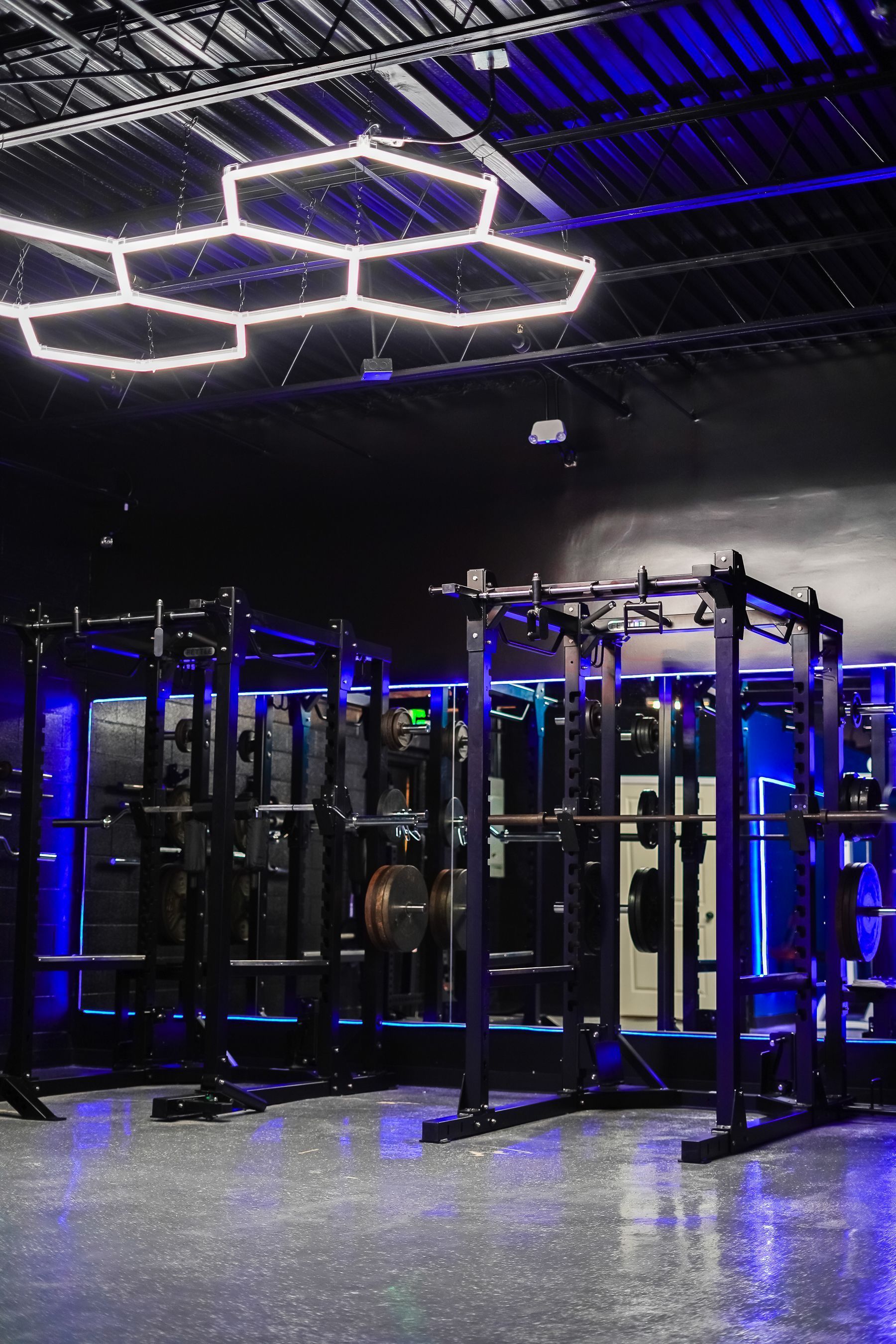 A gym with a lot of exercise equipment and a ceiling light.