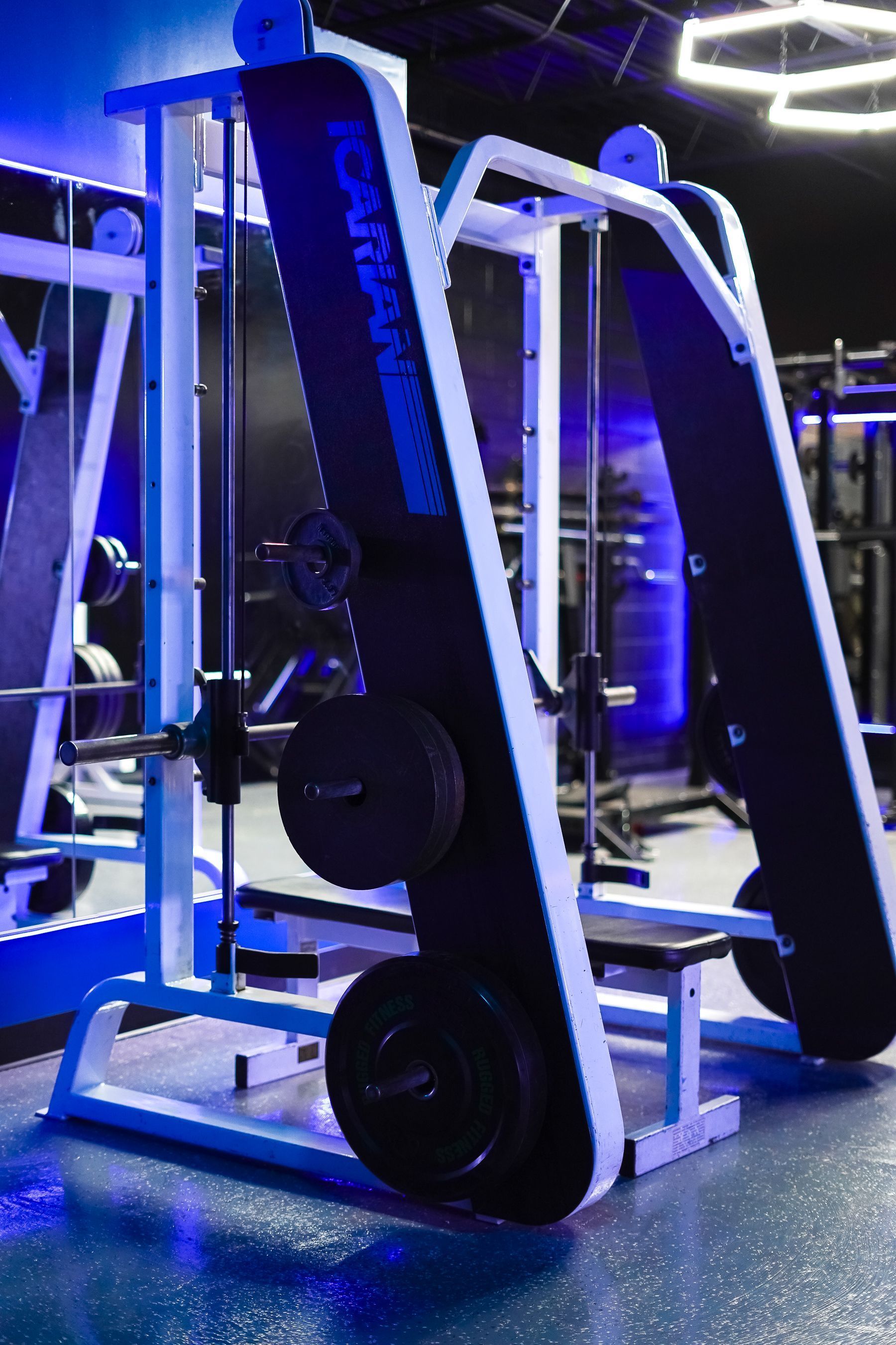 A gym with a lot of exercise equipment in it.