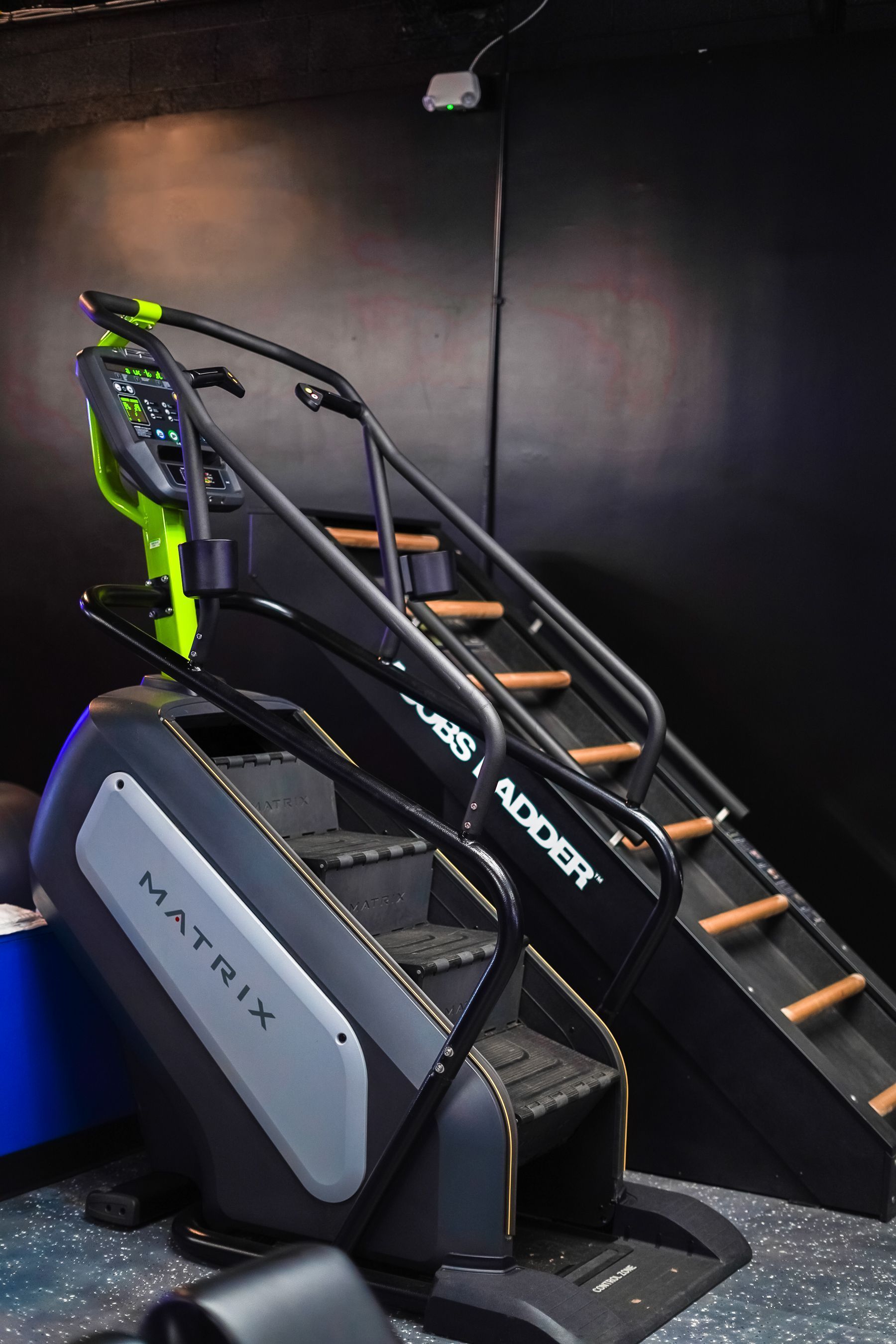 A treadmill with stairs attached to it in a gym.