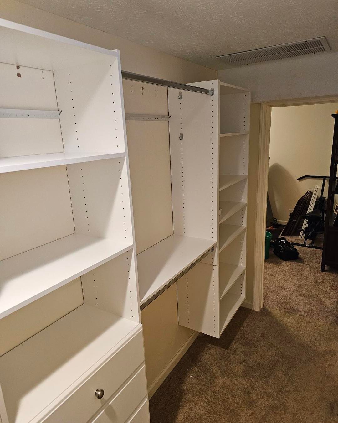 A closet with a lot of shelves and drawers.