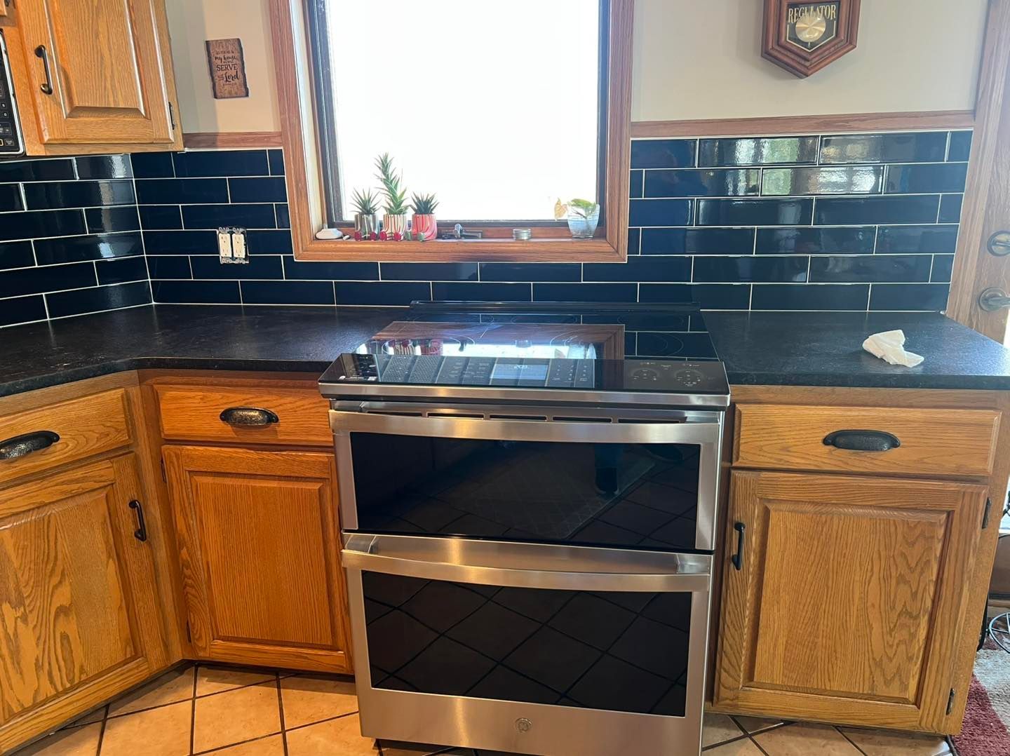 A kitchen with stainless steel appliances and wooden cabinets.