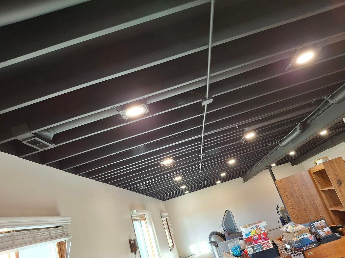 A room with a black ceiling and a lot of lights on it.