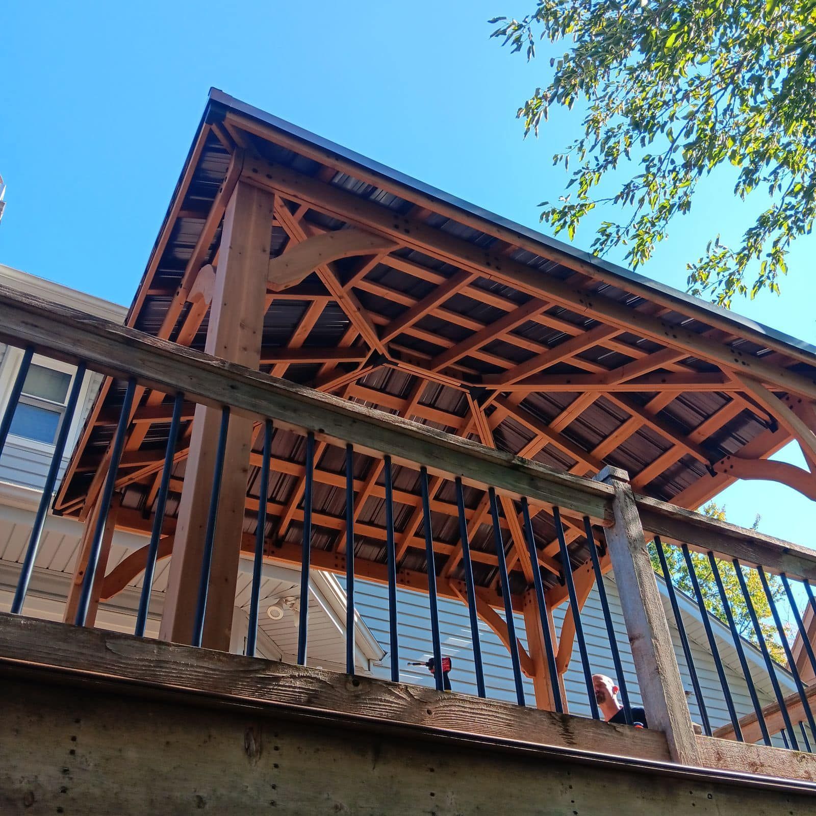 Looking up at a wooden structure with a blue sky in the background.