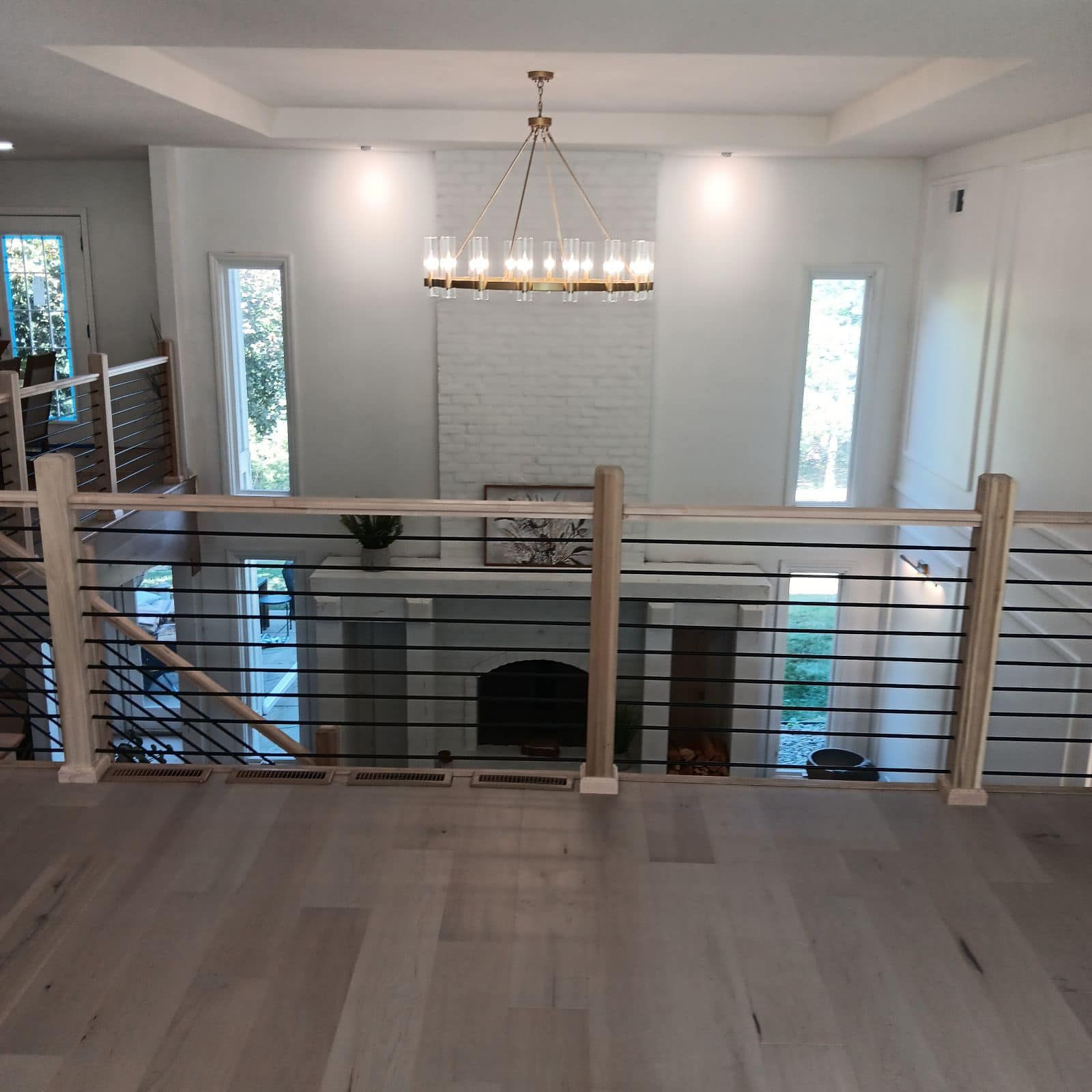 A living room with a fireplace and stairs leading up to it.