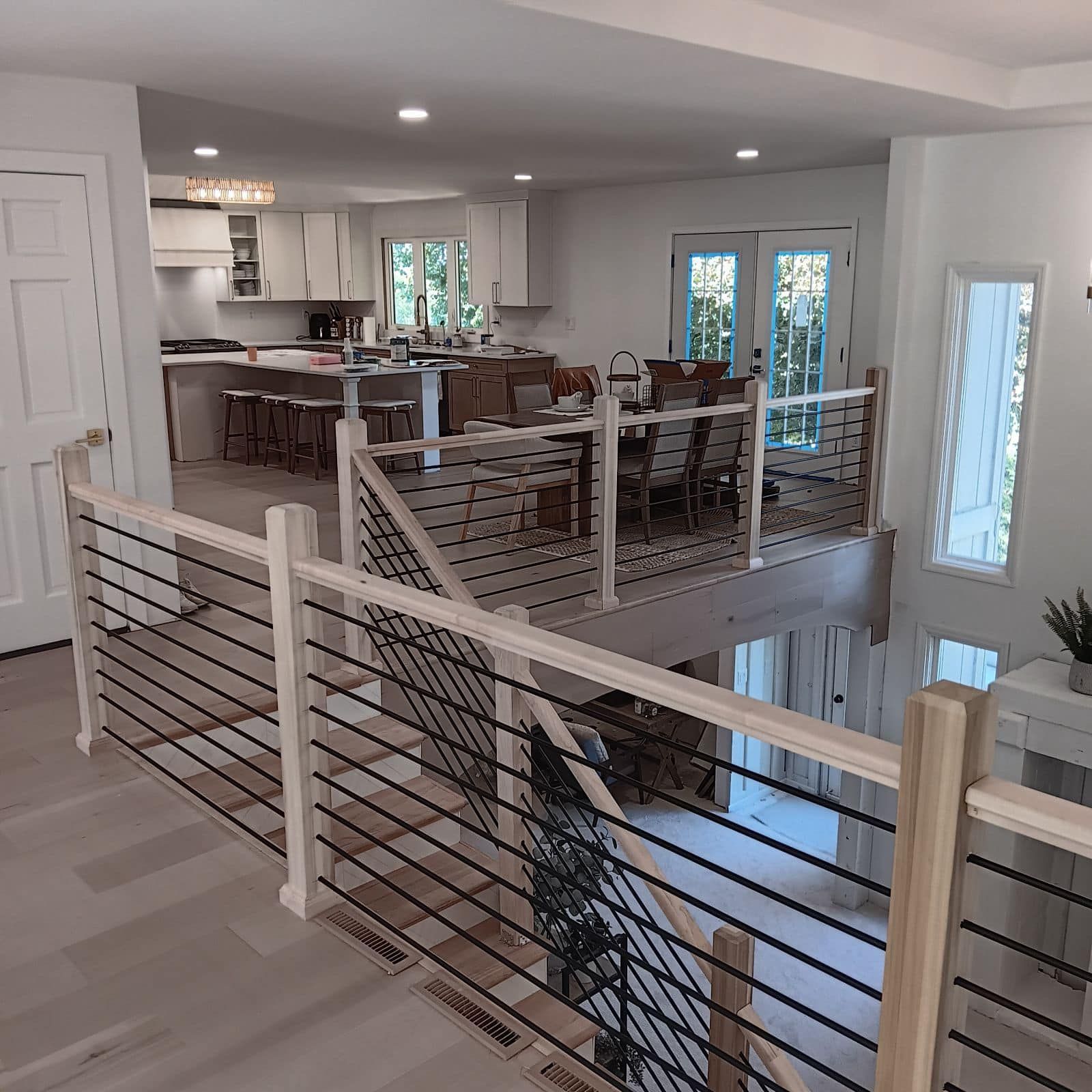 A staircase leading up to a kitchen and dining room.