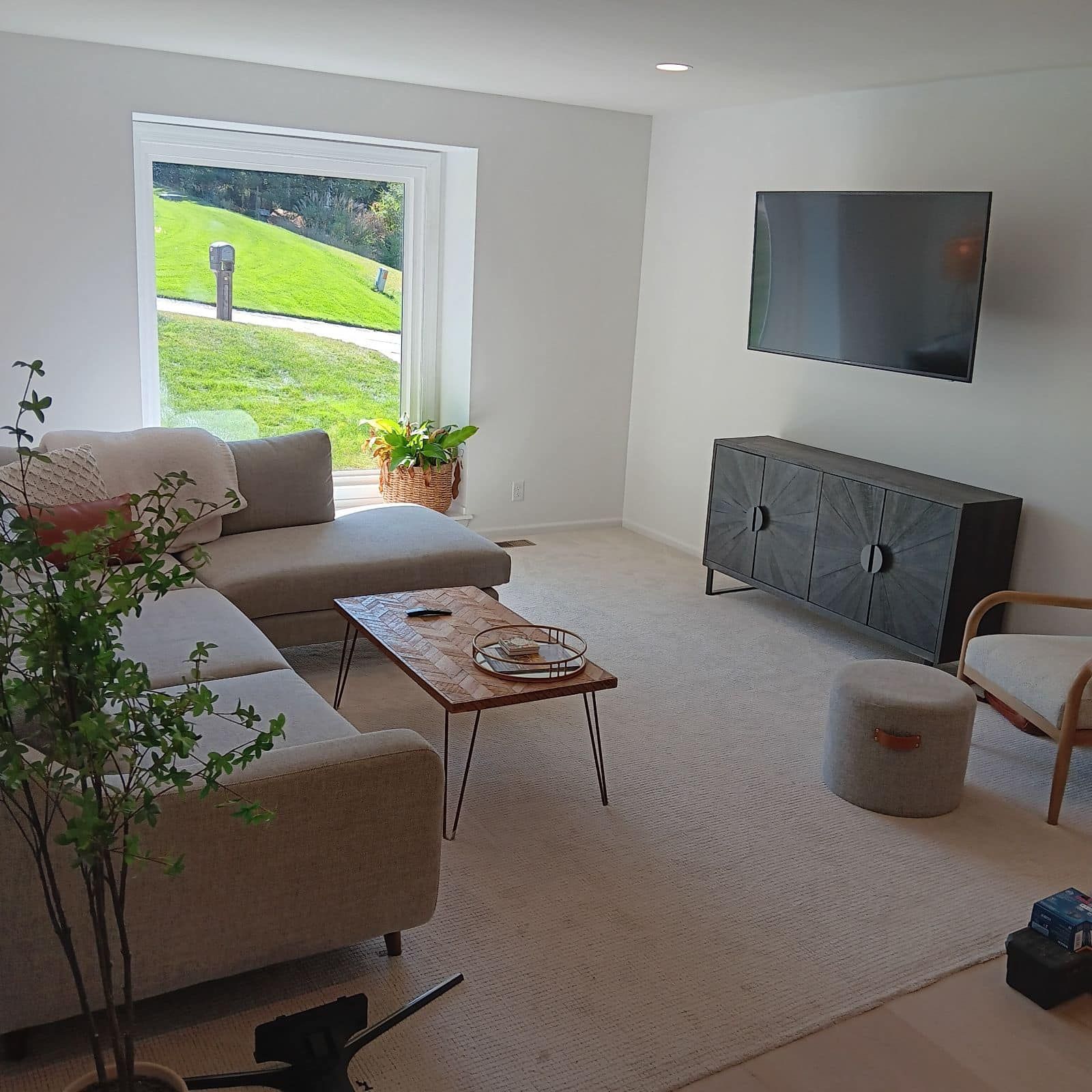 A living room with a couch, chair, coffee table, and television.