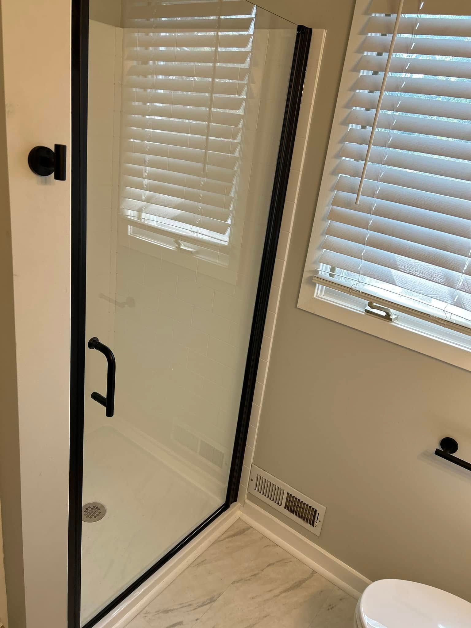 A bathroom with a walk in shower and a toilet.