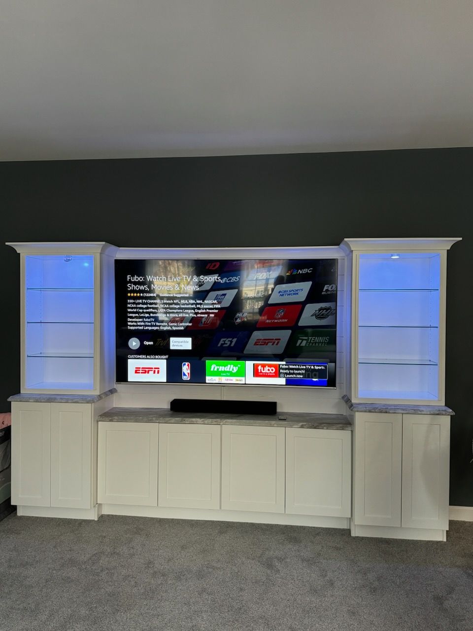 a large entertainment center with a flat screen tv