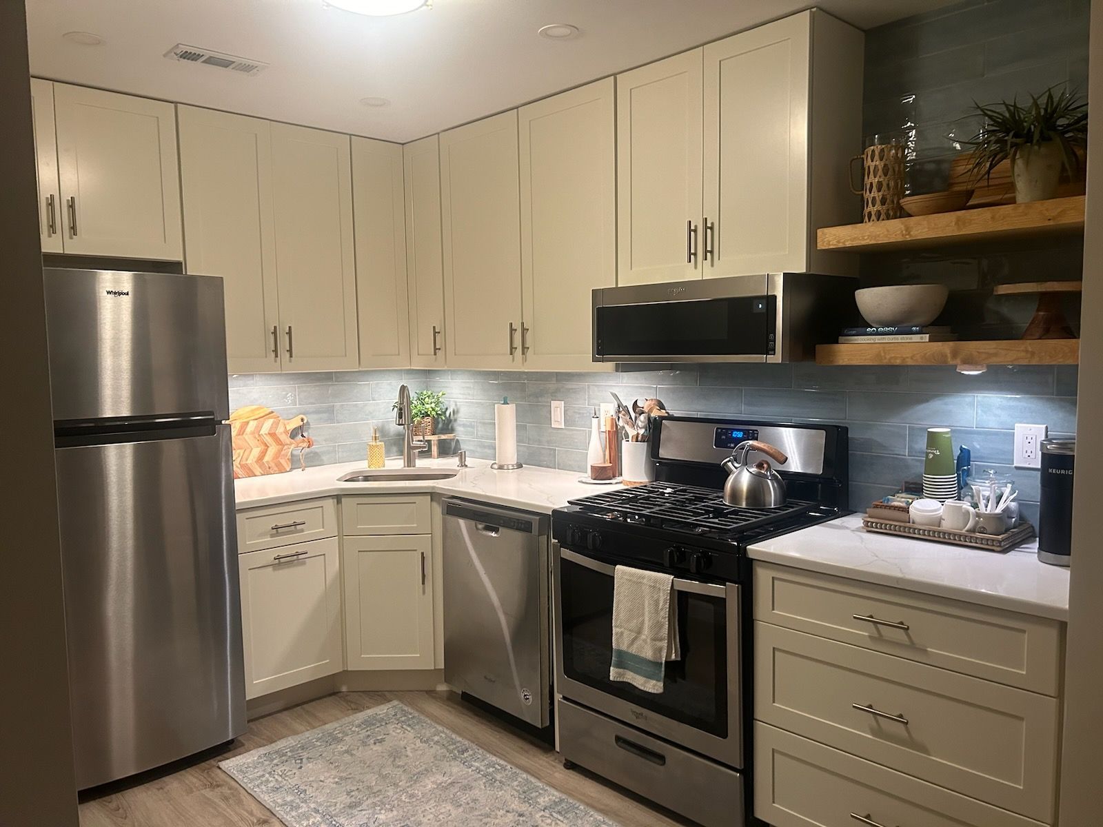 a kitchen with stainless steel appliances and white cabinets .