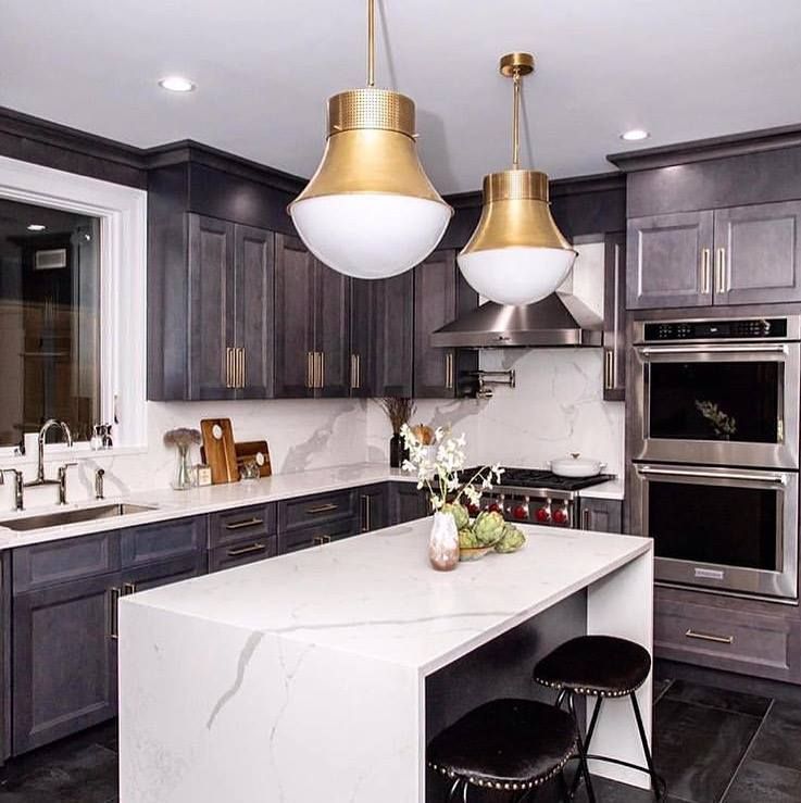 A kitchen with stainless steel appliances and a large island