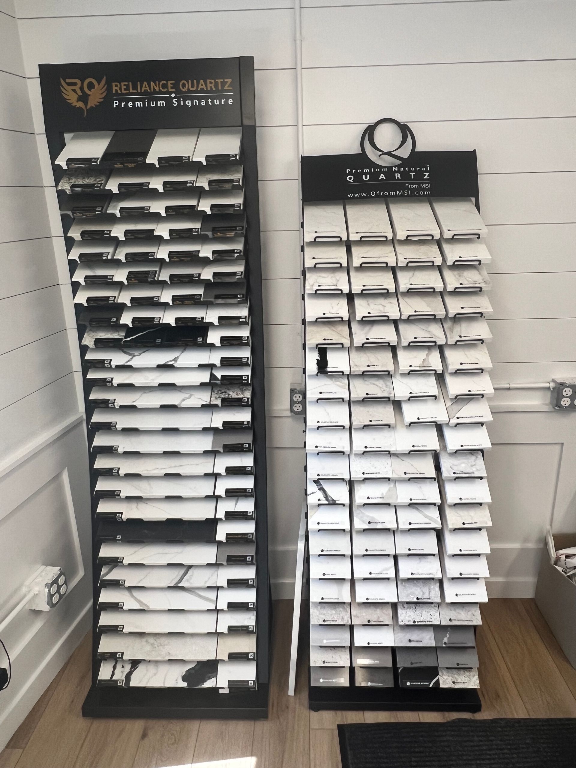 Two display stands are filled with different types of marble.