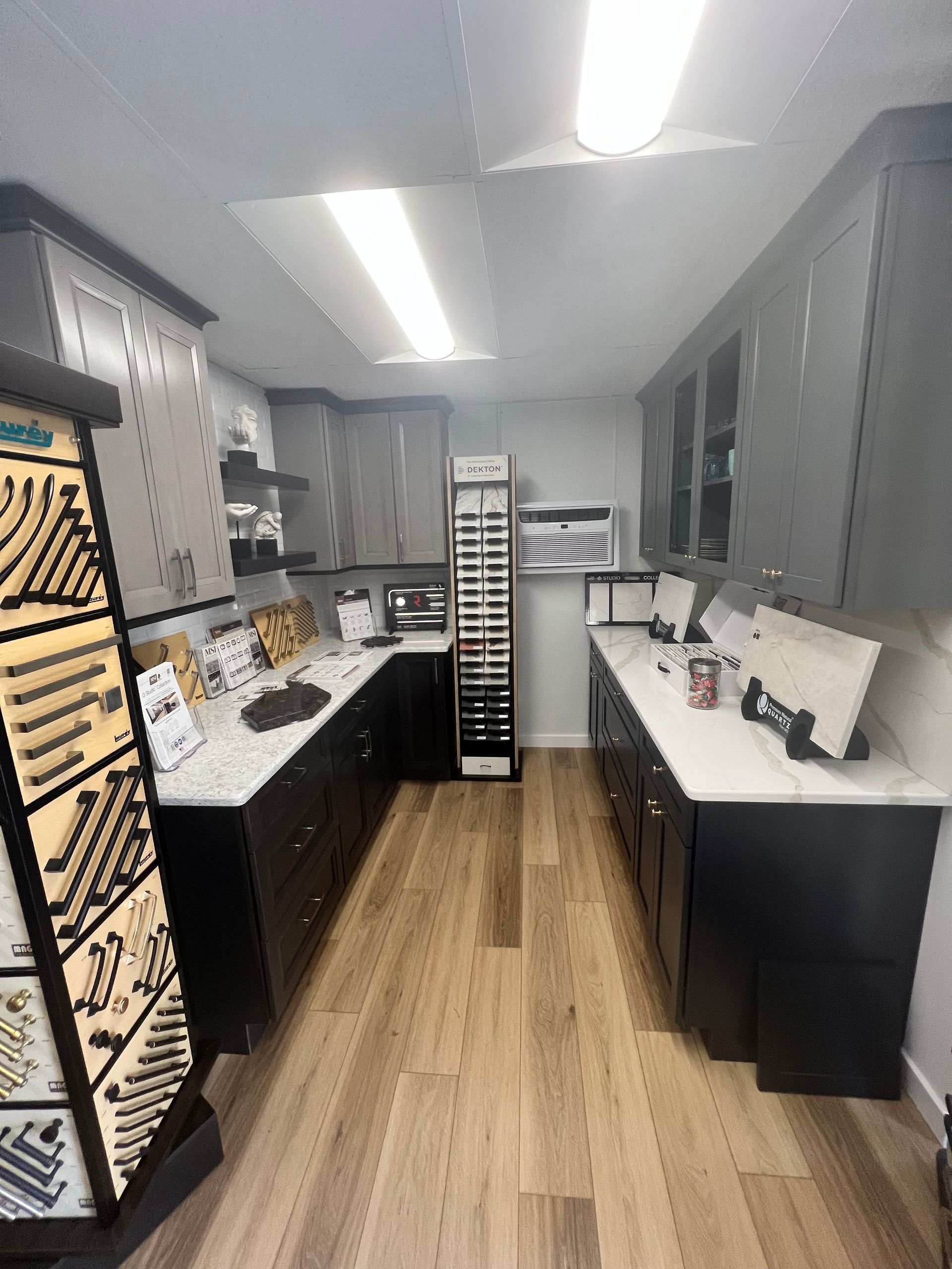 A kitchen with a lot of cabinets, countertops, and a sink.