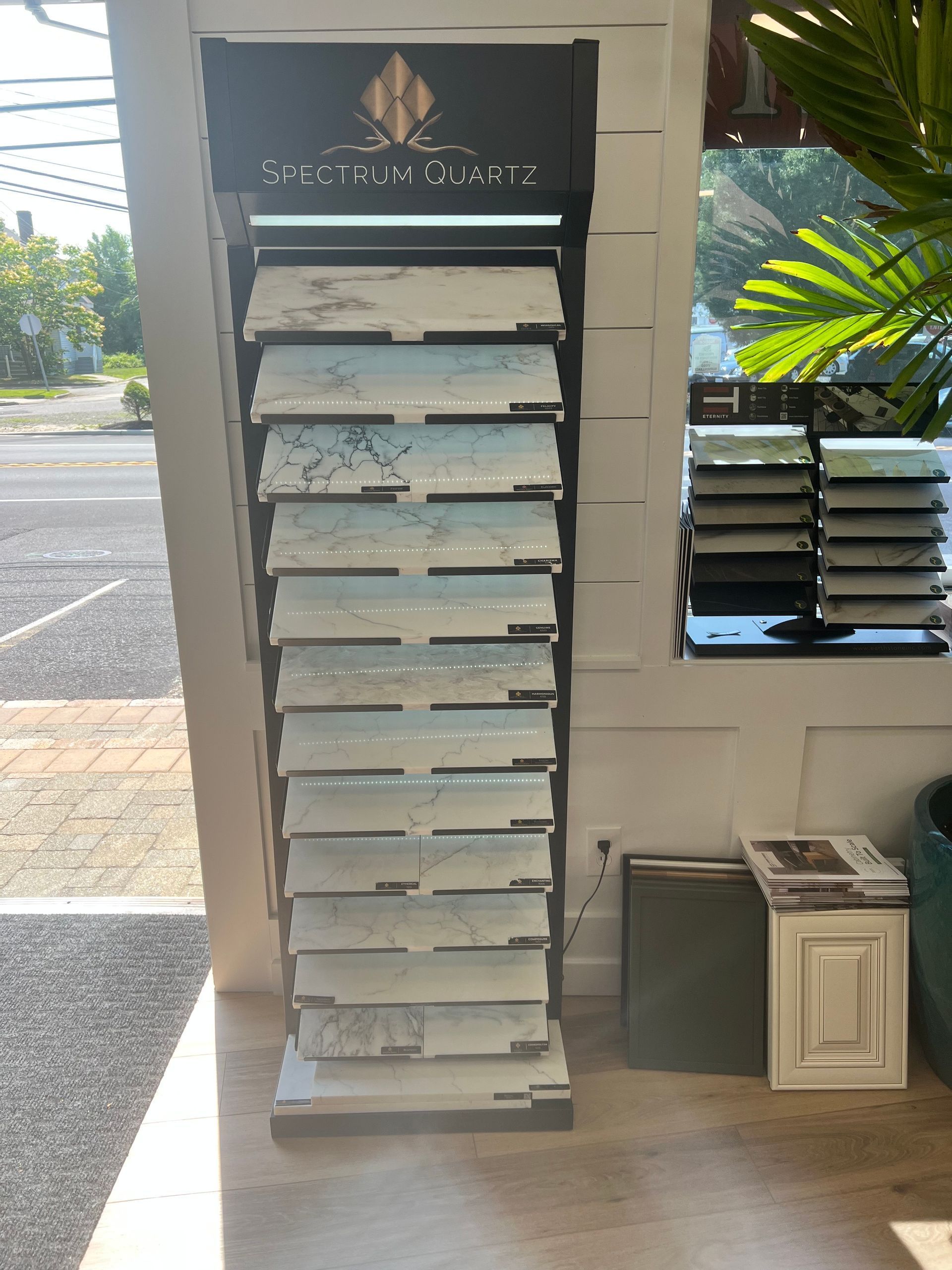 A marble display rack is sitting in a room next to a window.