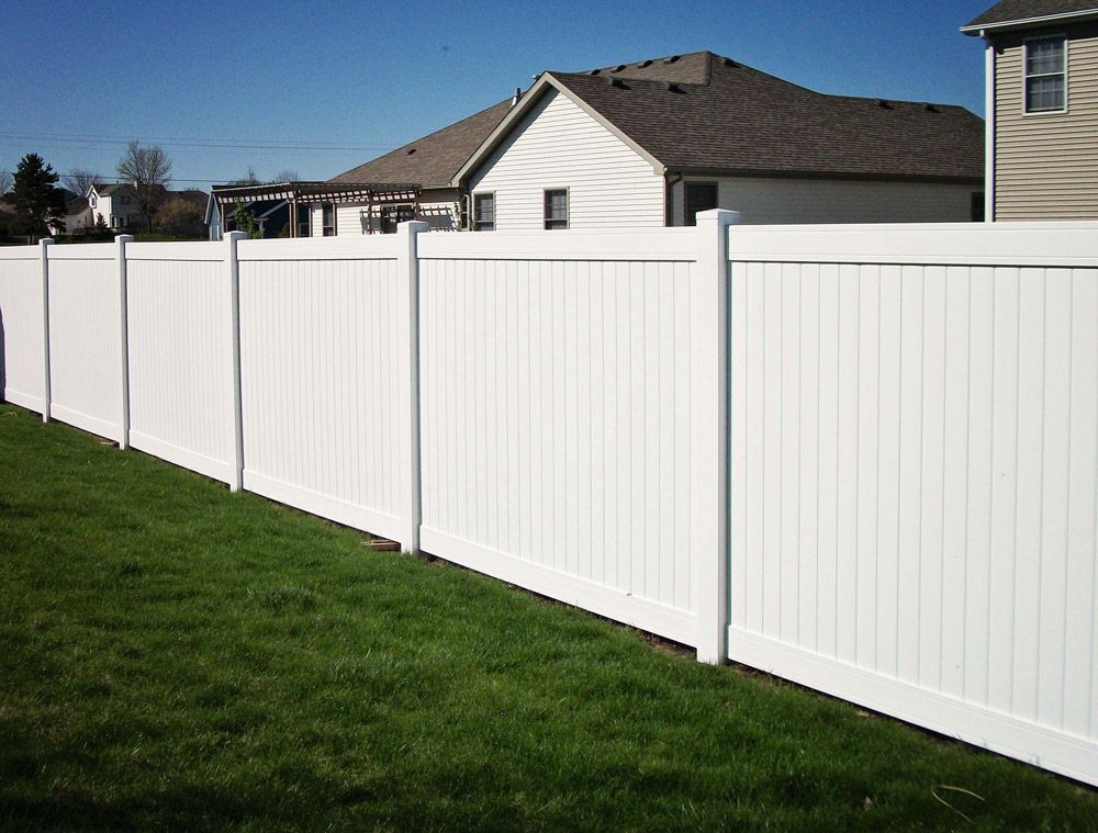 A white fence with a house in the background