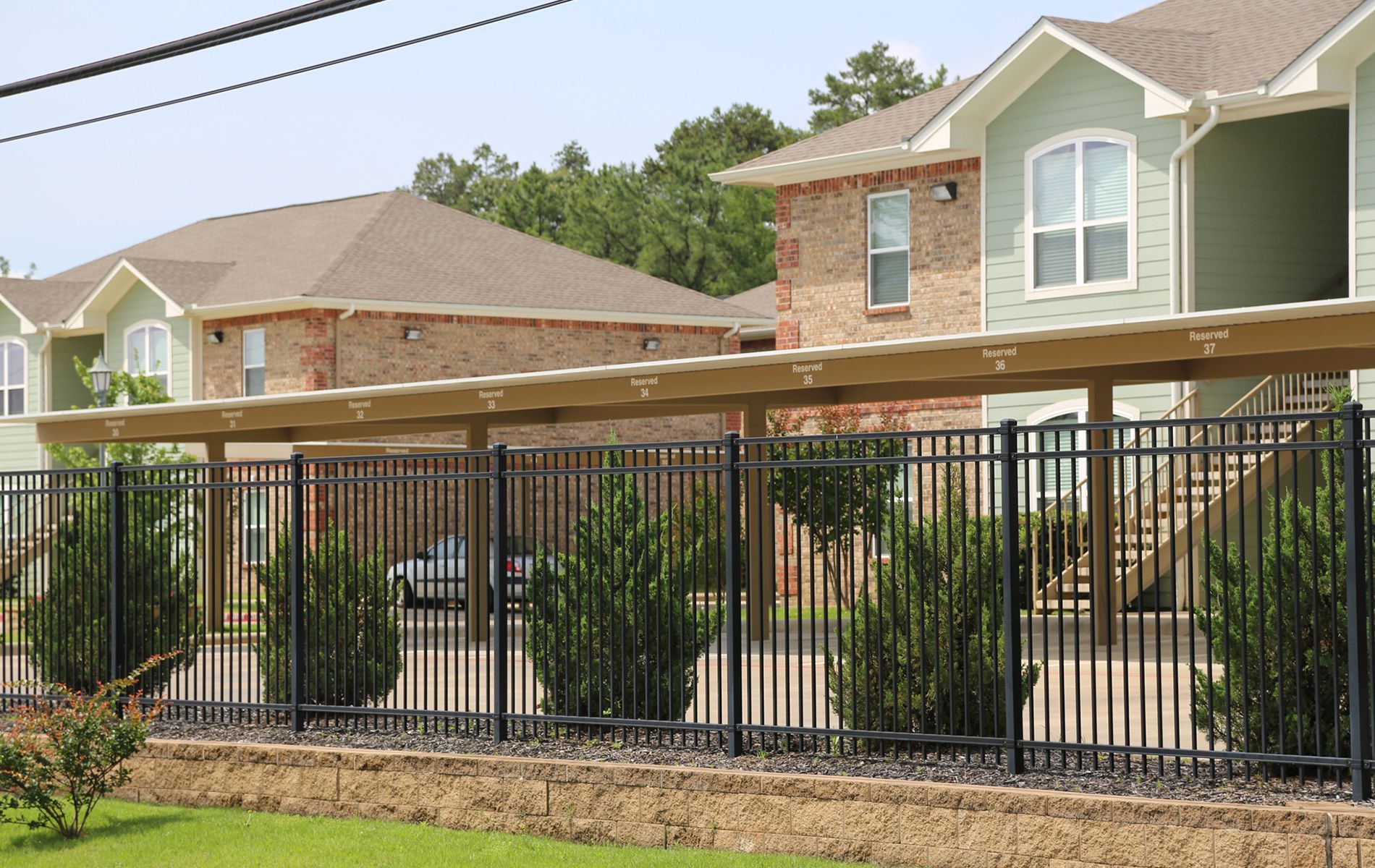 A row of houses with a fence in front of them