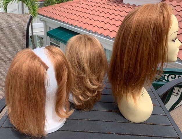 3 hairpieces on a head mannequin