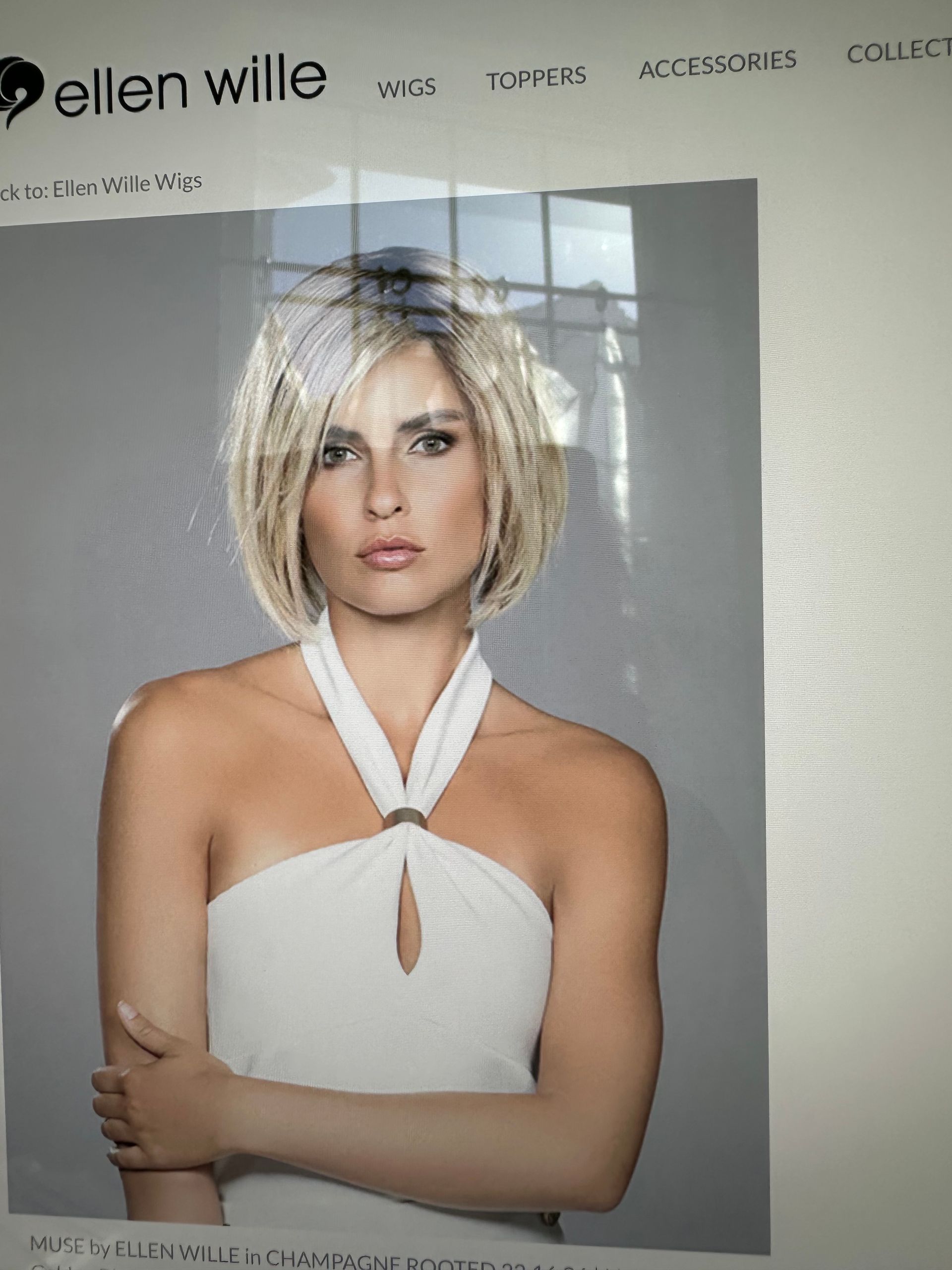 A woman in a white dress is on the ellen wille website