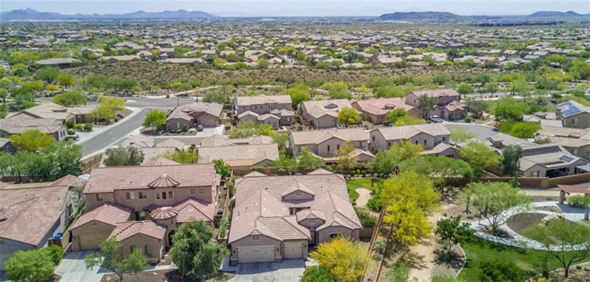 An aerial view of a residential area with lots of houses and trees.