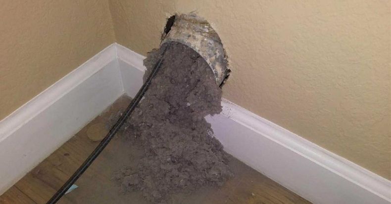 A vacuum cleaner is cleaning a hole in a wall.