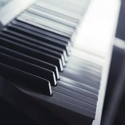 A close up of a piano keyboard with the keys visible.