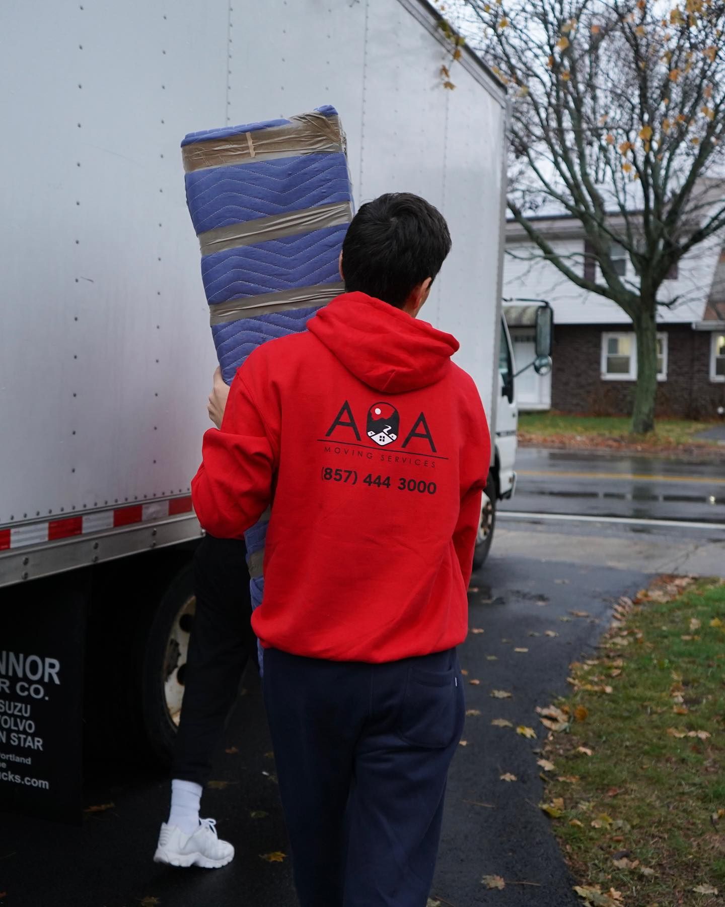 A man wearing a red a2a moving services sweatshirt