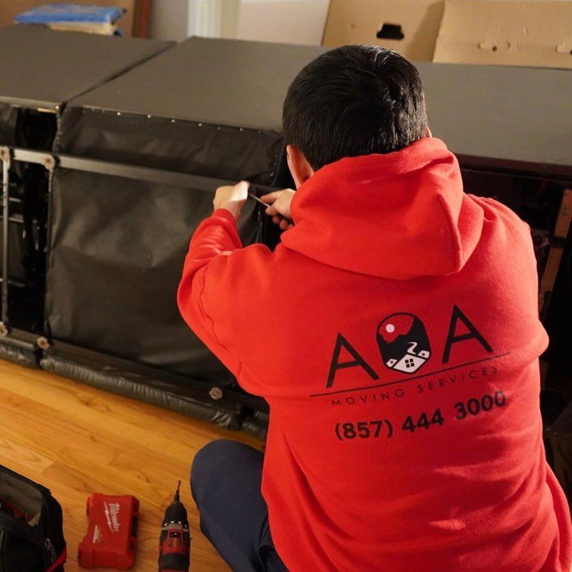A man wearing a red a2a moving services sweatshirt