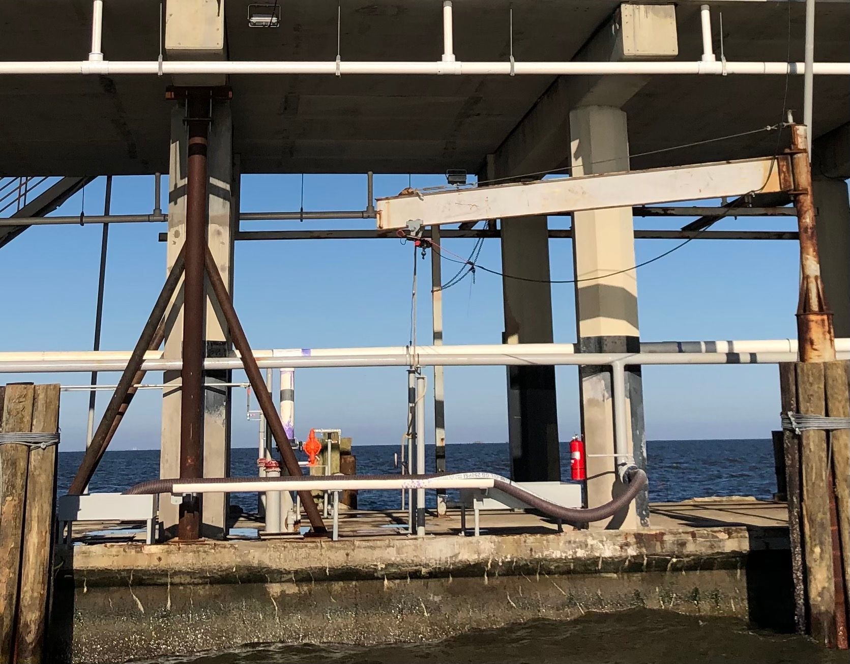 A concrete structure with pipes going into the ocean