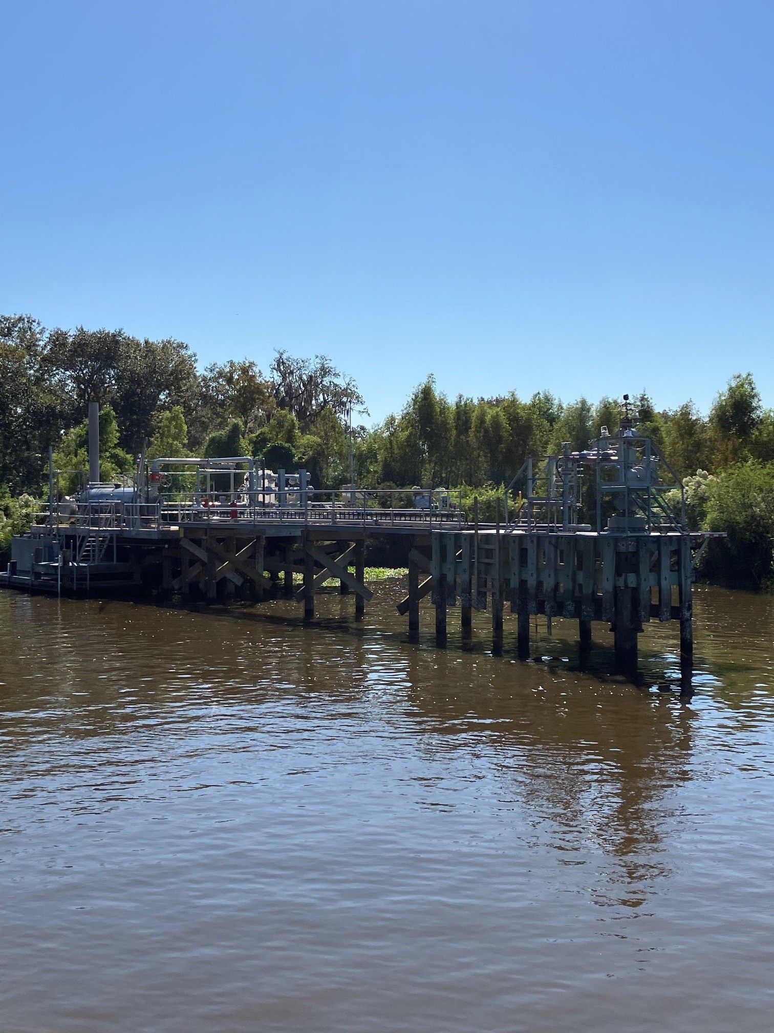 A bridge over a body of water with trees in the background
