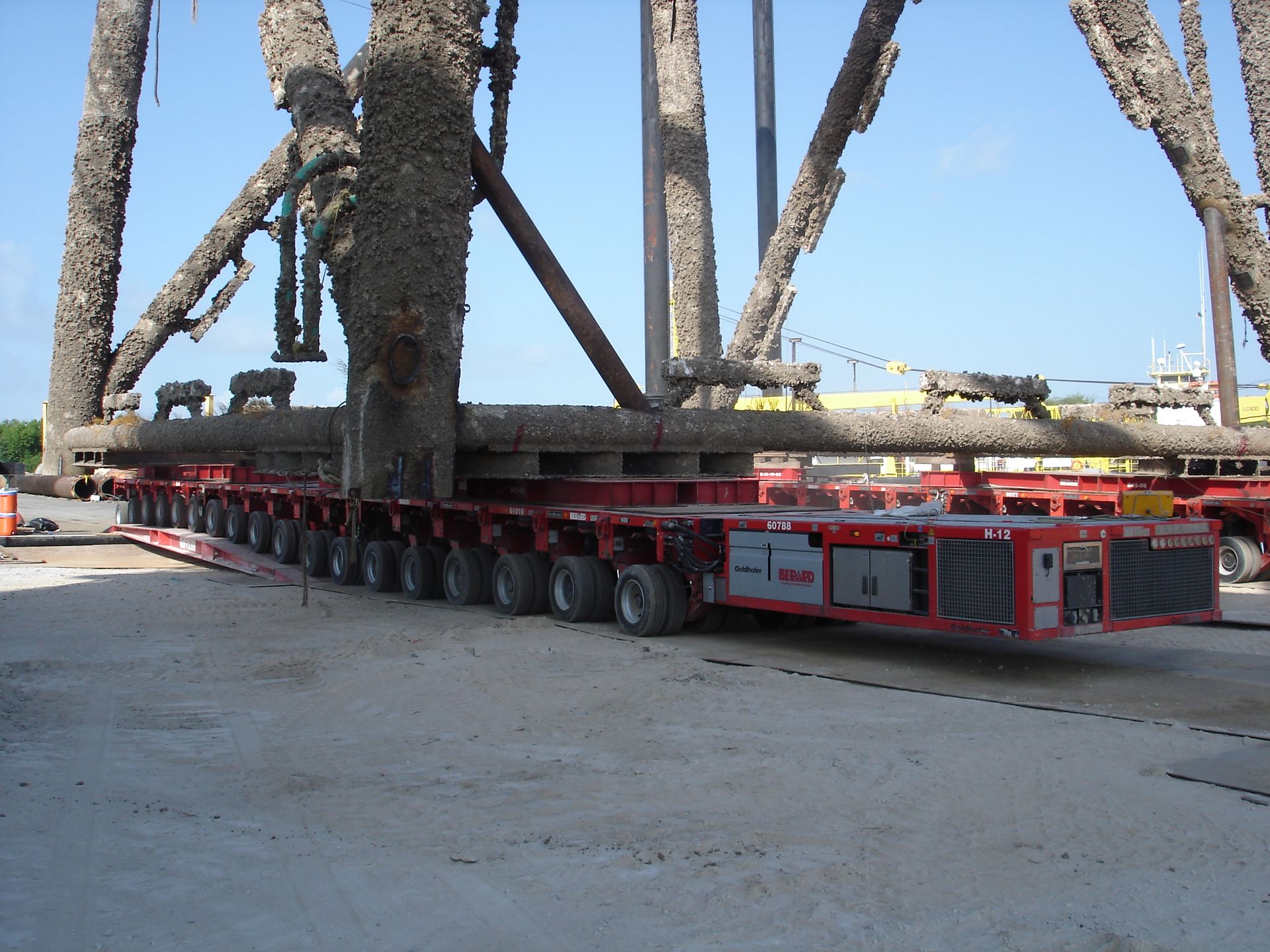 A red and white trailer with a large object on it
