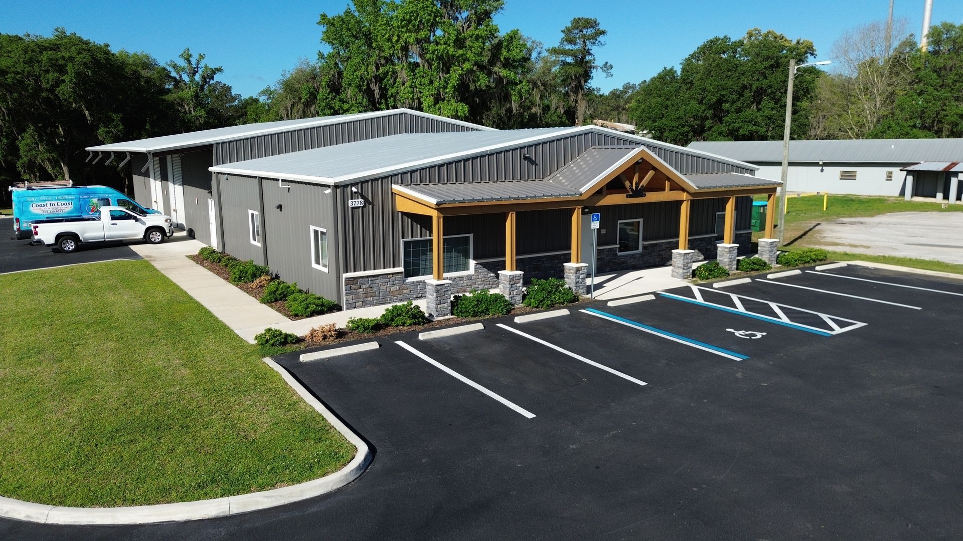 Accessible building exterior with parking spaces and a ramp in front