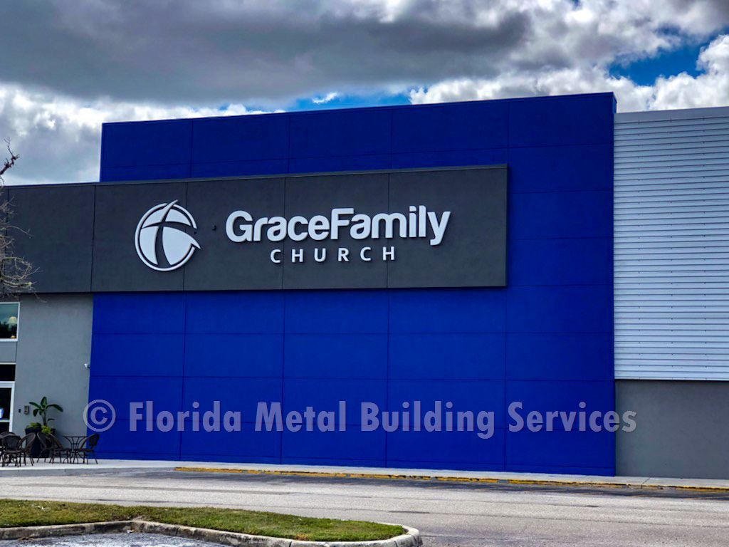 GraceFamily Church sign on a blue building under a cloudy sky