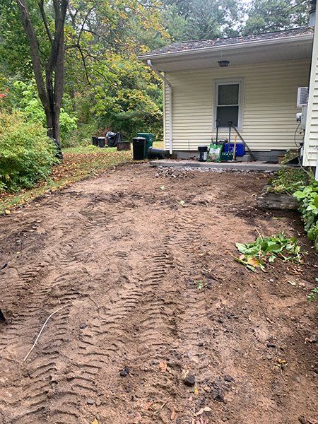 There is a lot of dirt in front of a house.