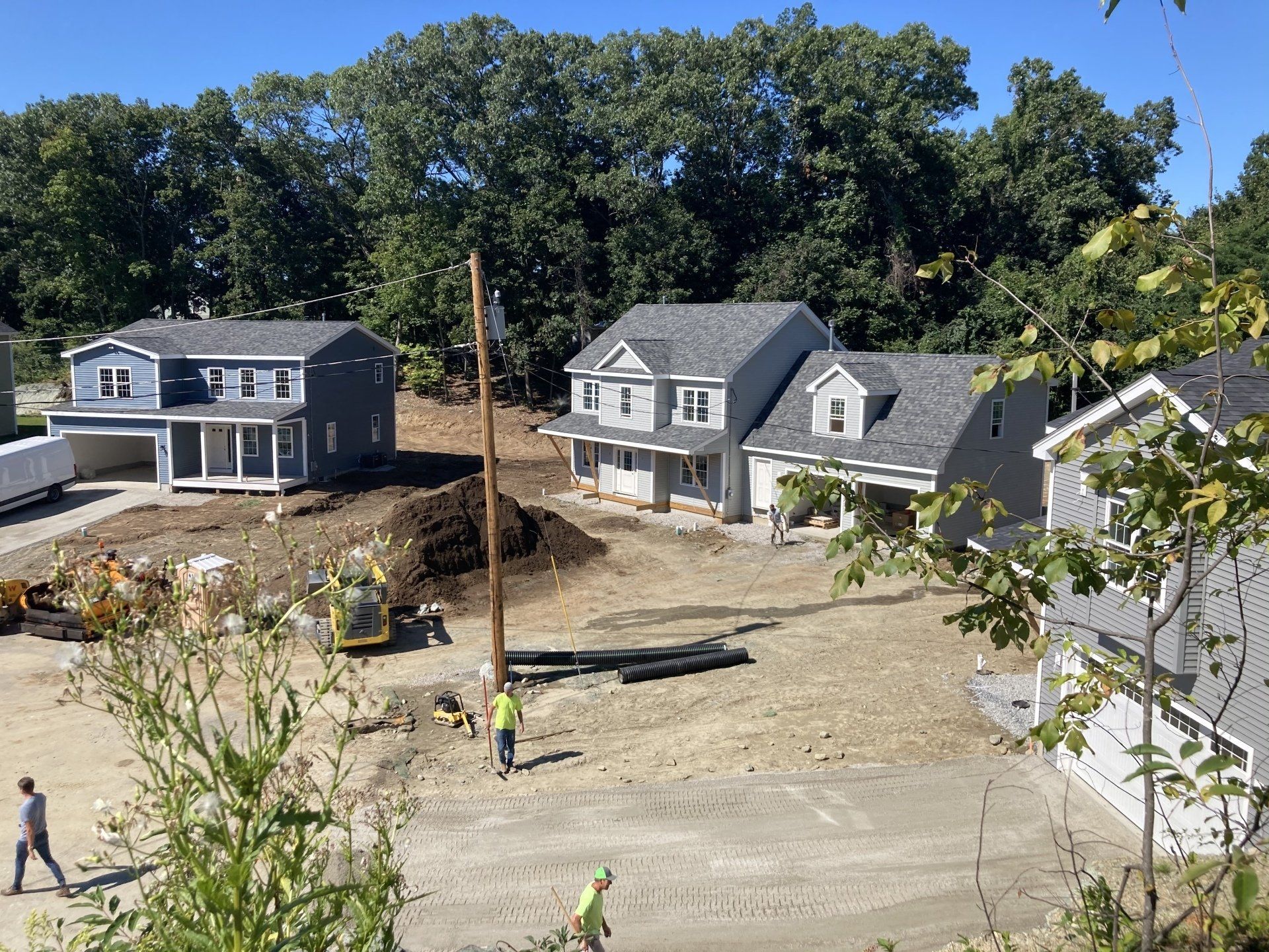 A group of houses are being built in a residential area.