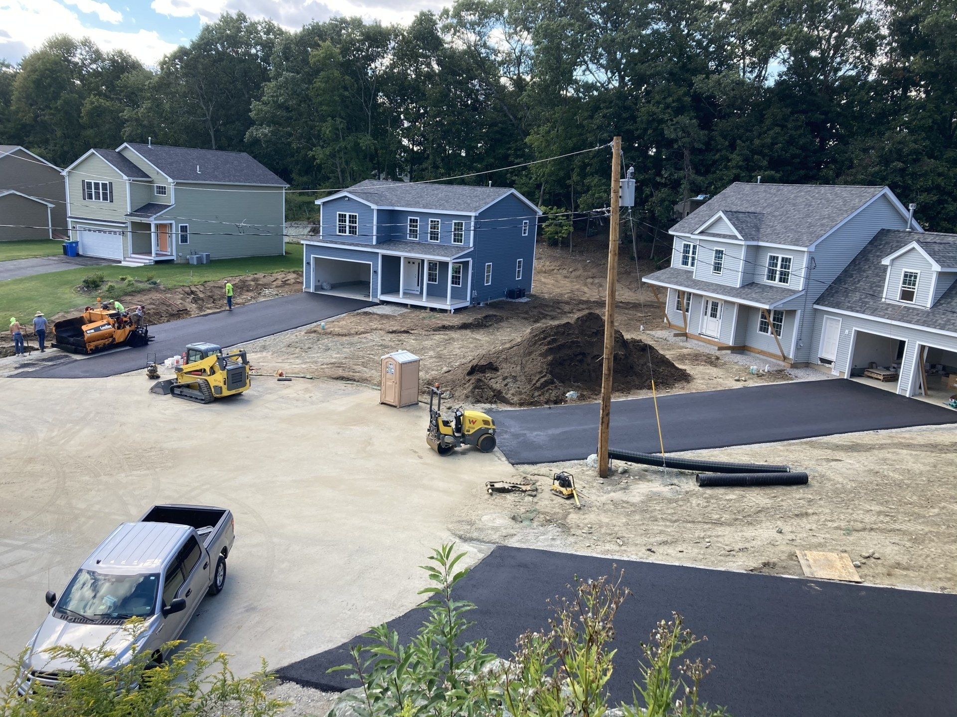A group of houses are being built in a residential area.