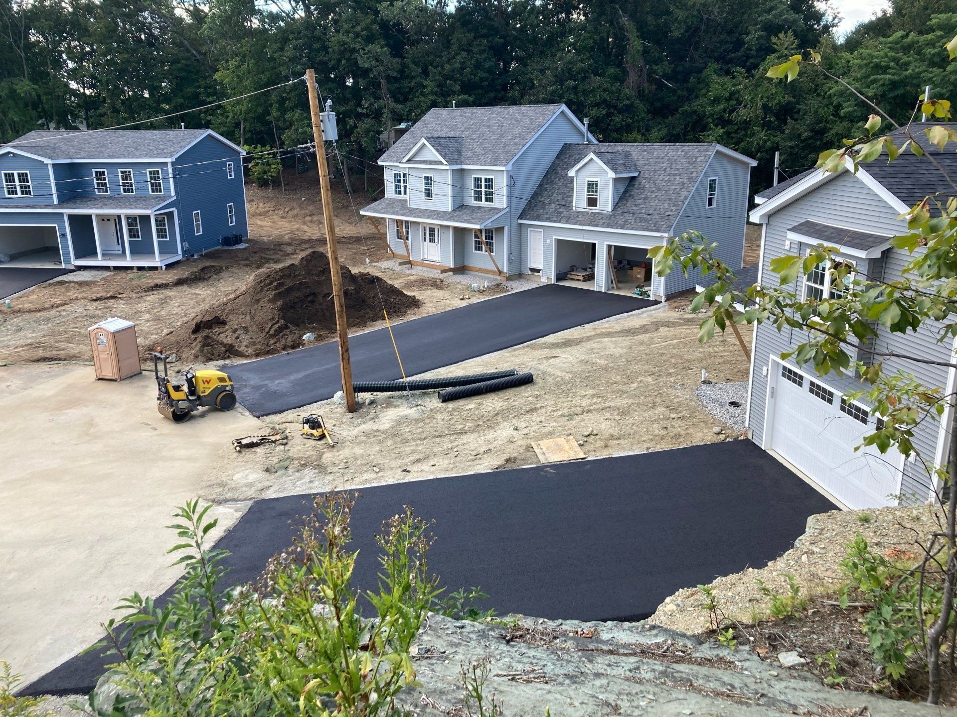A row of houses are being built in a residential area.