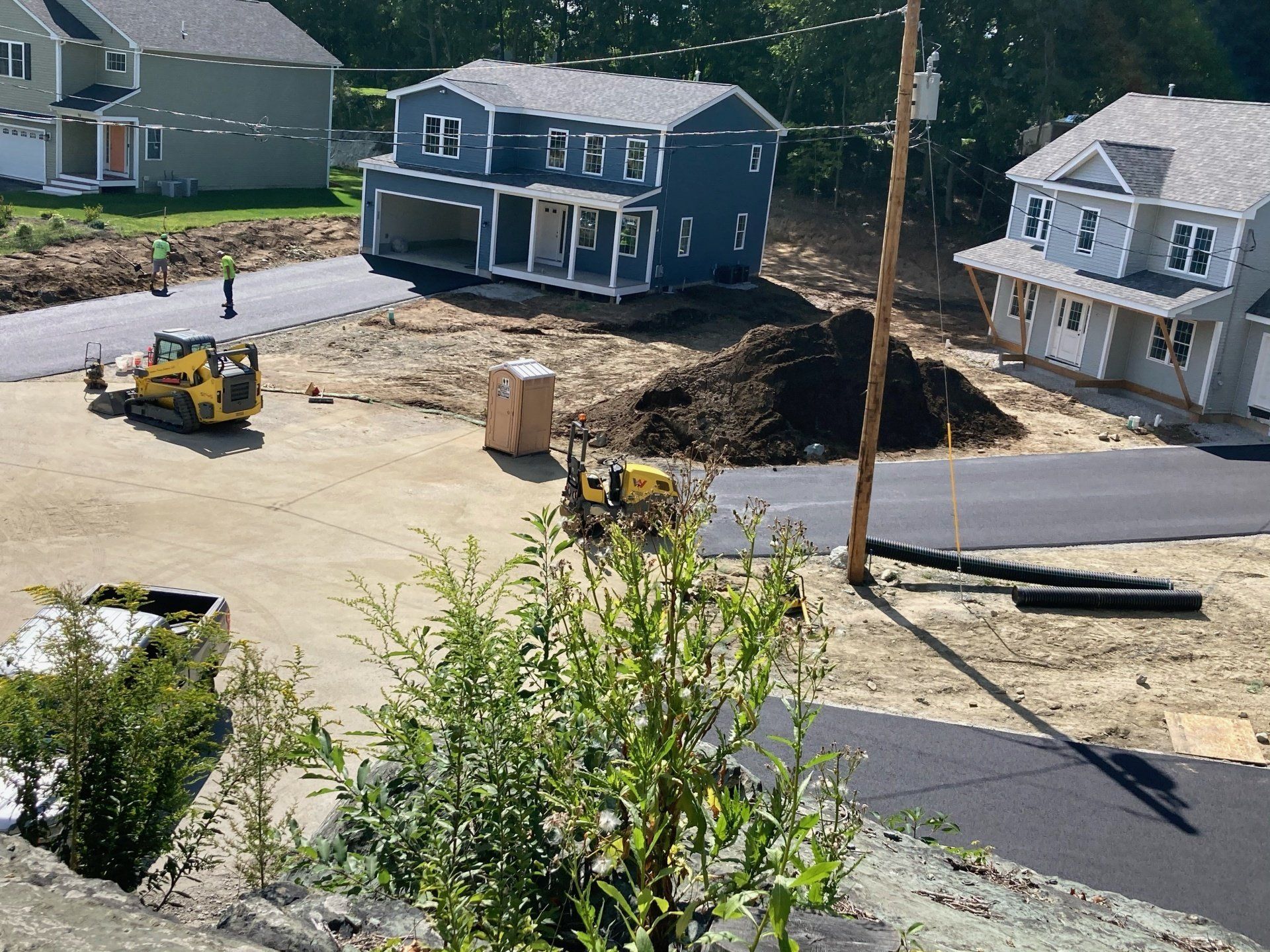 A construction site with a blue house in the middle