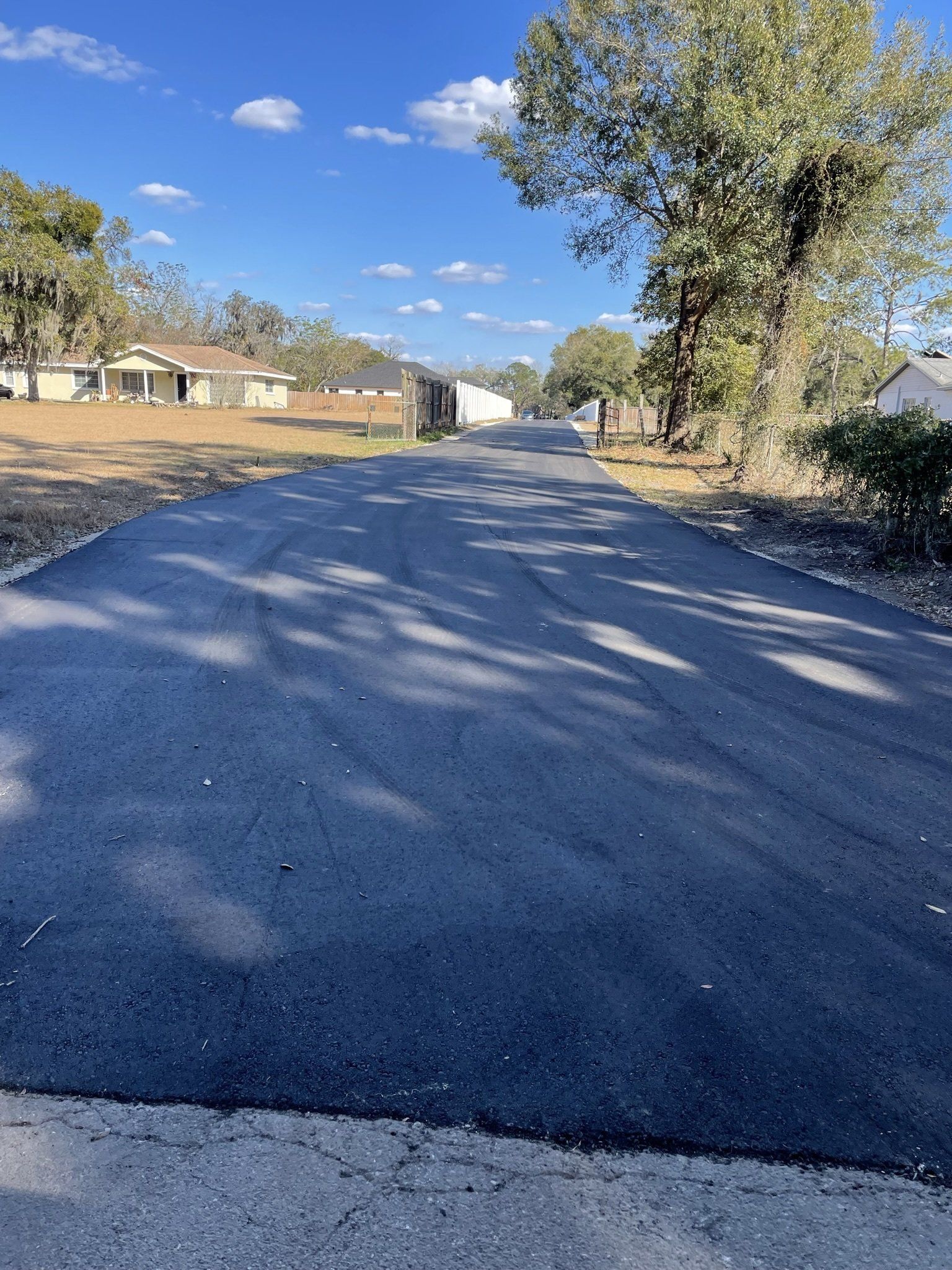 A road with a lot of trees on the side of it.
