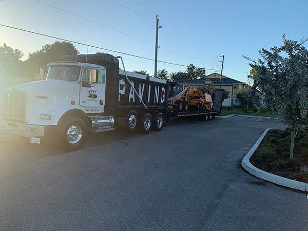 A dump truck is parked on the side of the road.
