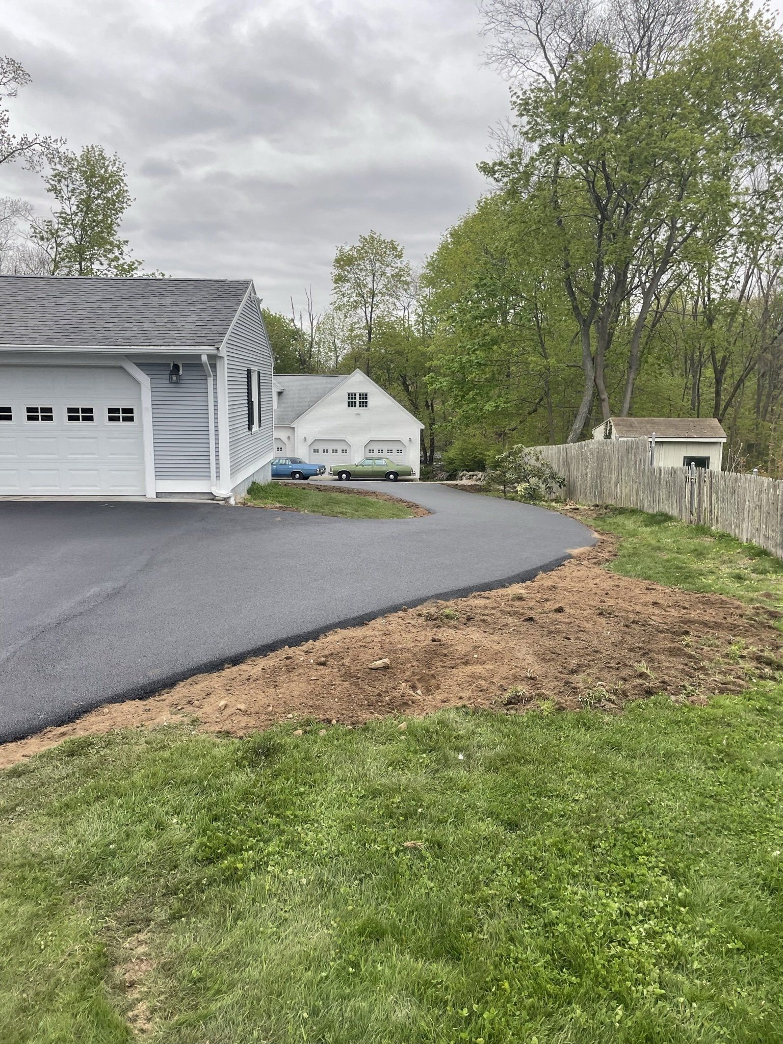 A house with a garage and a driveway in front of it.