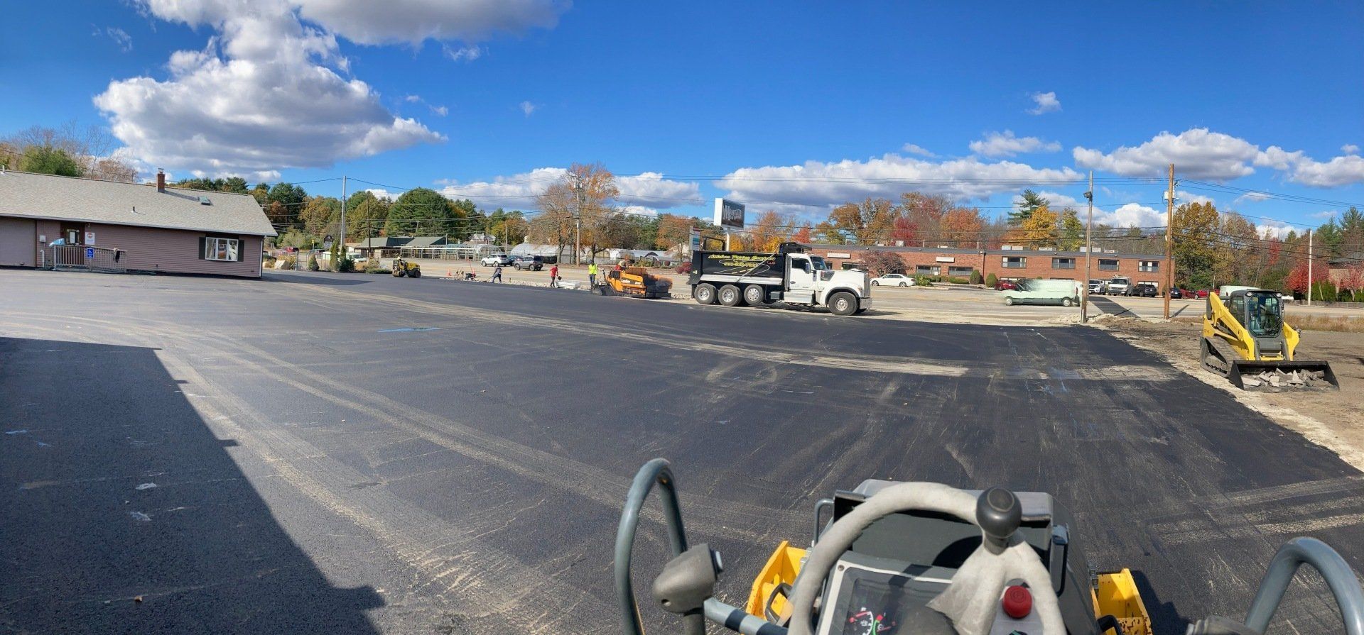 A panoramic view of a parking lot being built.