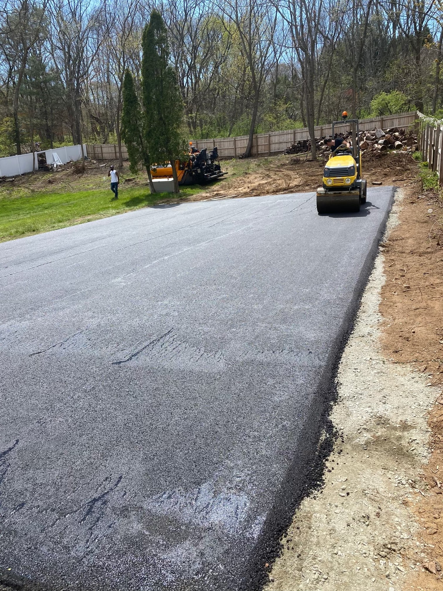 A machine is laying asphalt on a road.