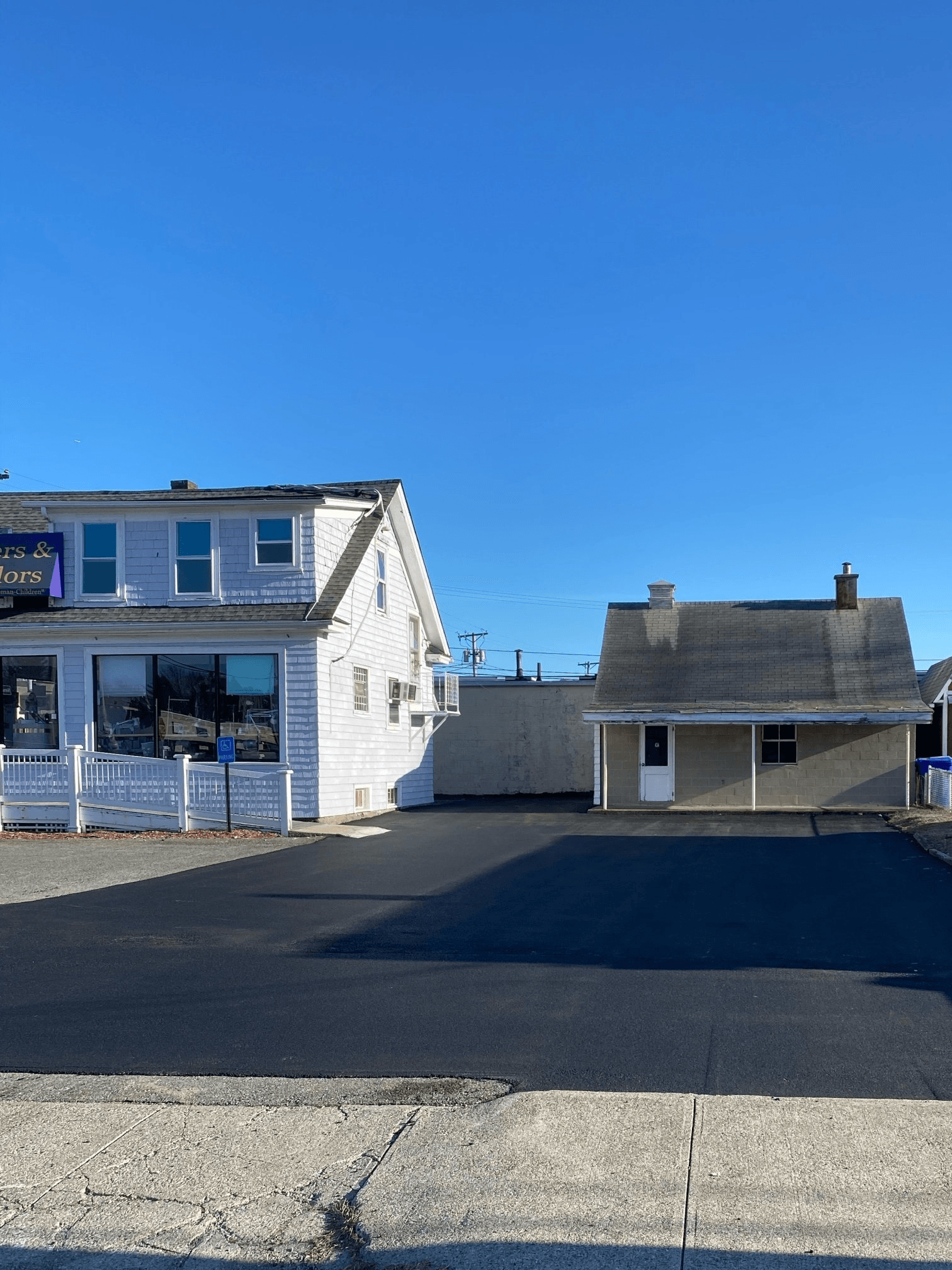 A white house with a blue sky in the background