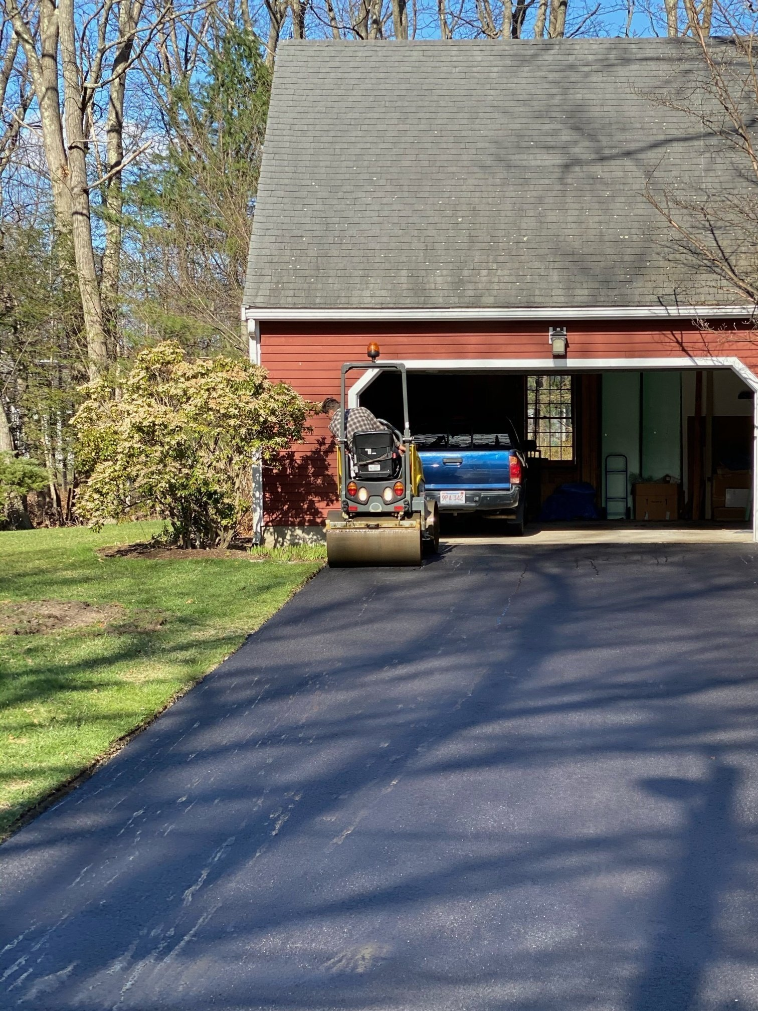 A truck is parked in a driveway in front of a garage.