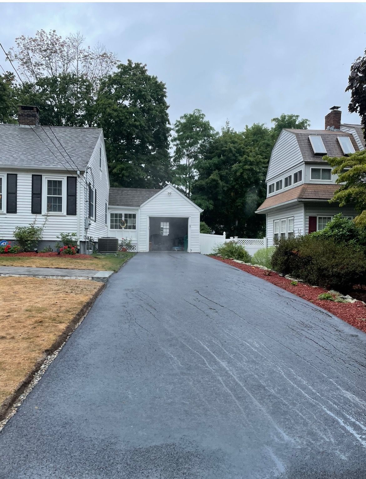 A driveway leading to a house with a garage.