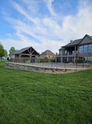 A large house with a large swimming pool in front of it