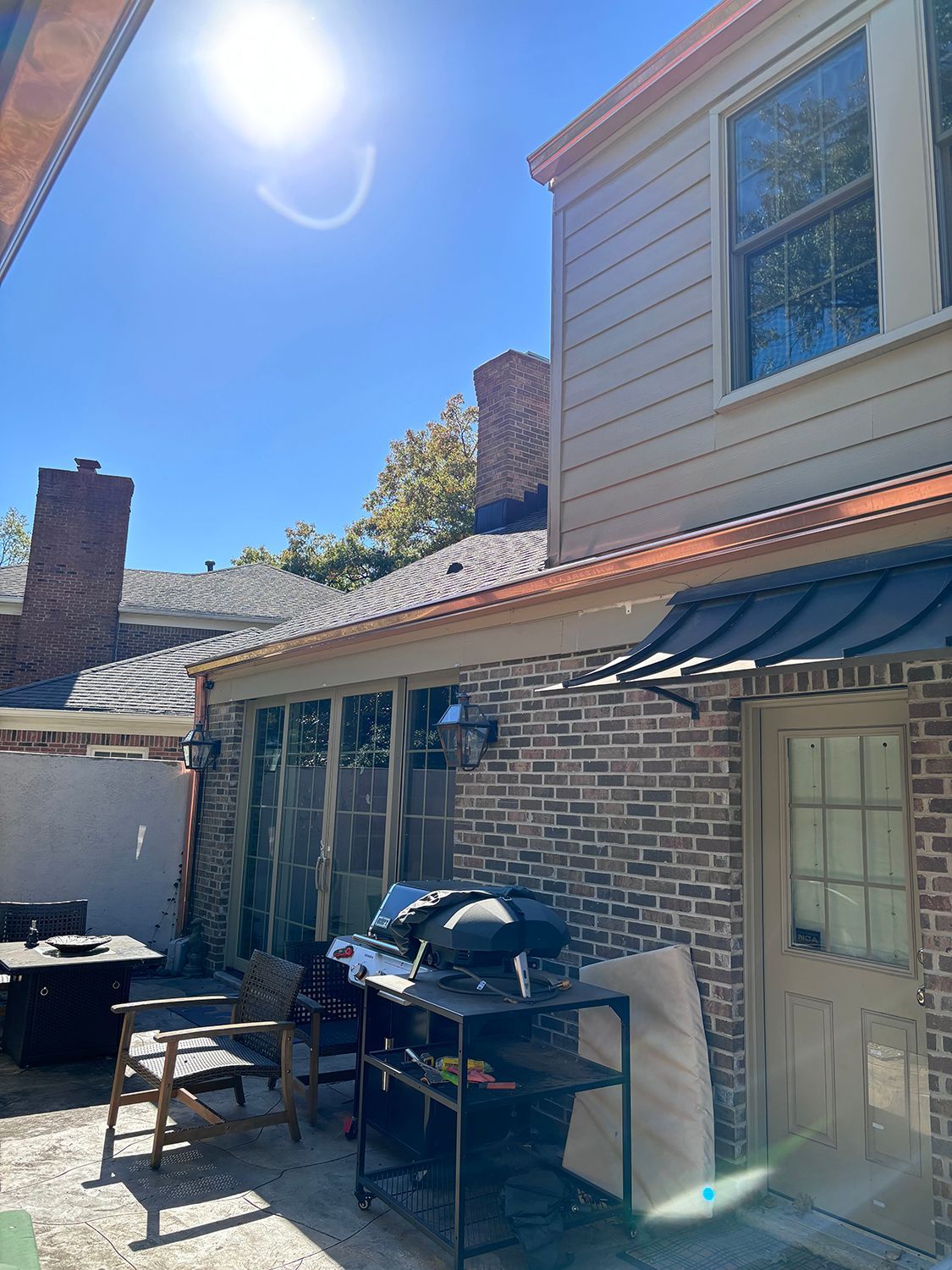 A brick house with a copper gutter.