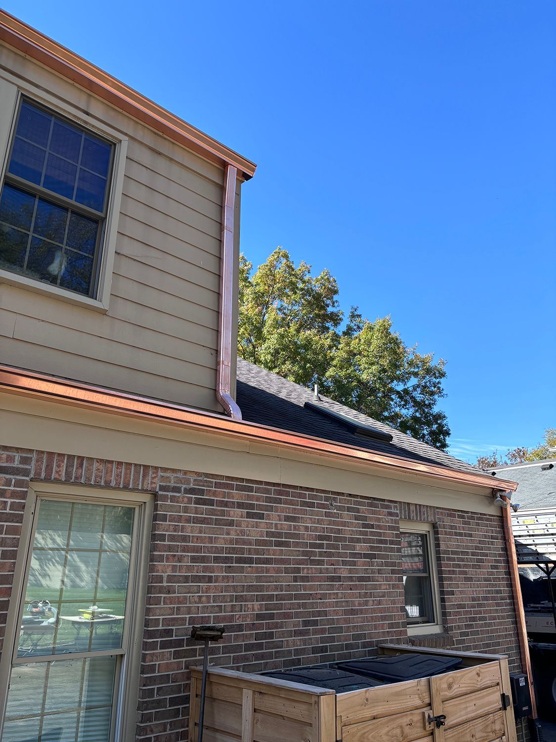A house with a copper gutter on the side of it.