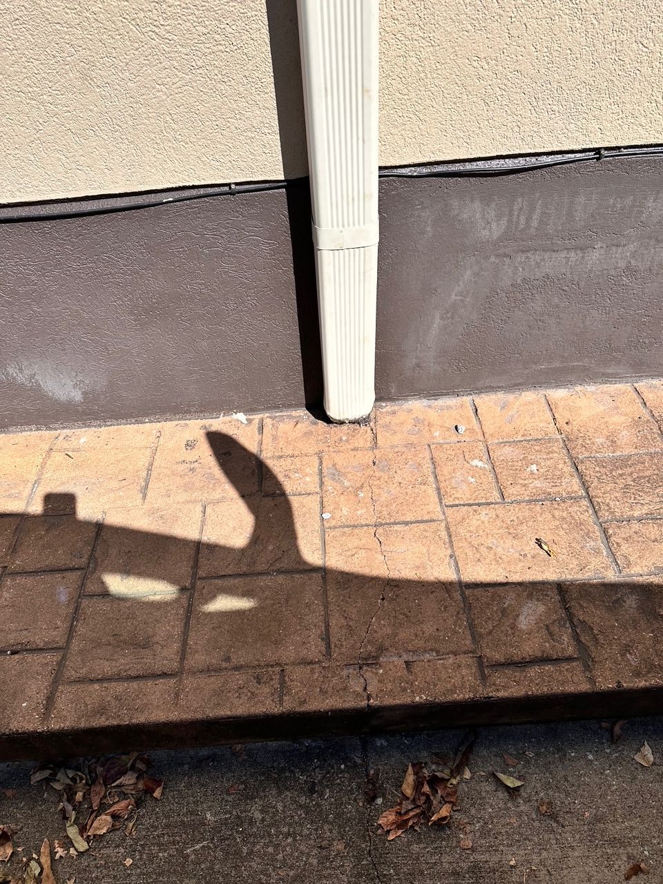 A downspout has been installed along the building's exterior.